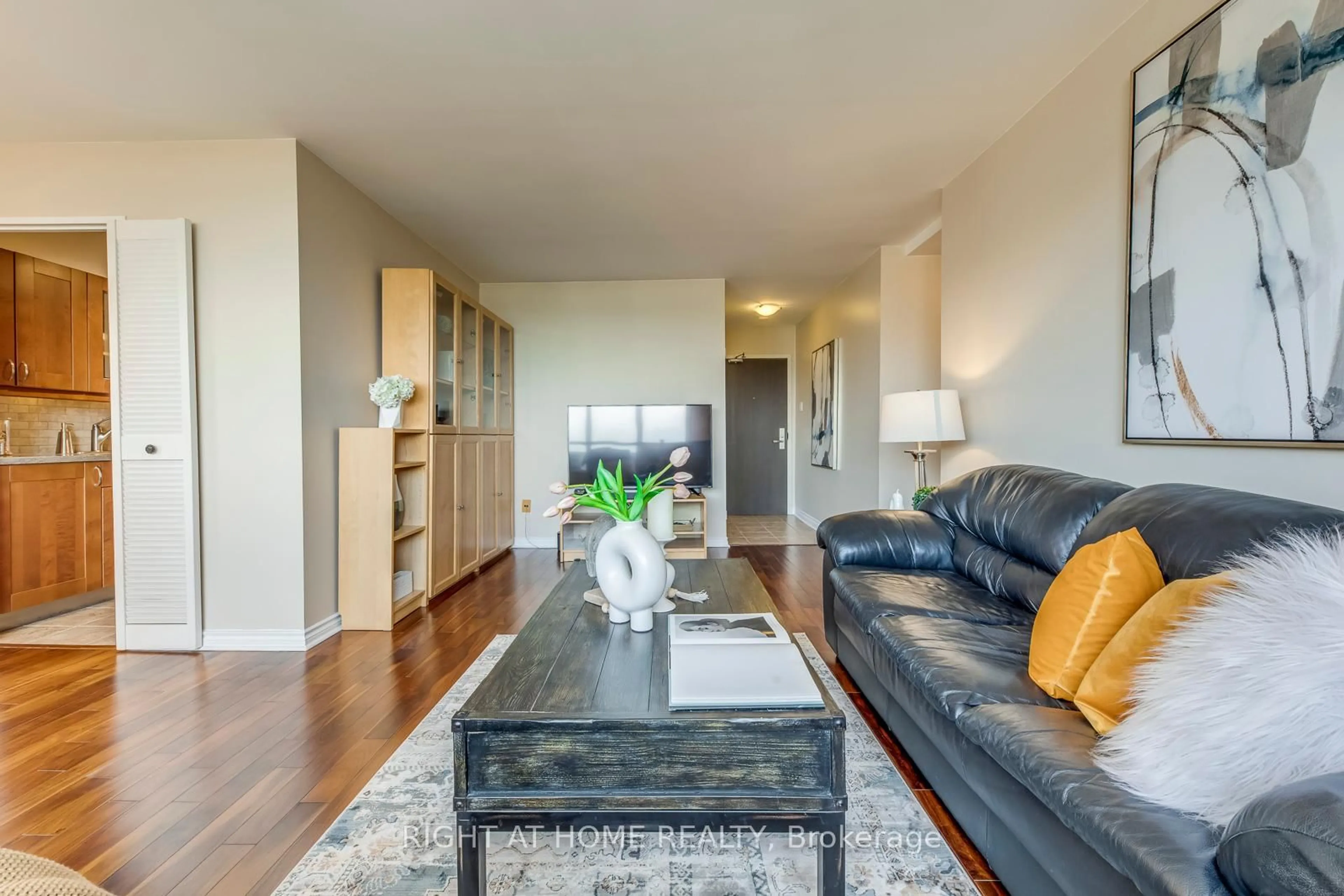 Living room with furniture, wood/laminate floor for 45 Southport St #PH11, Toronto Ontario M6S 3N5