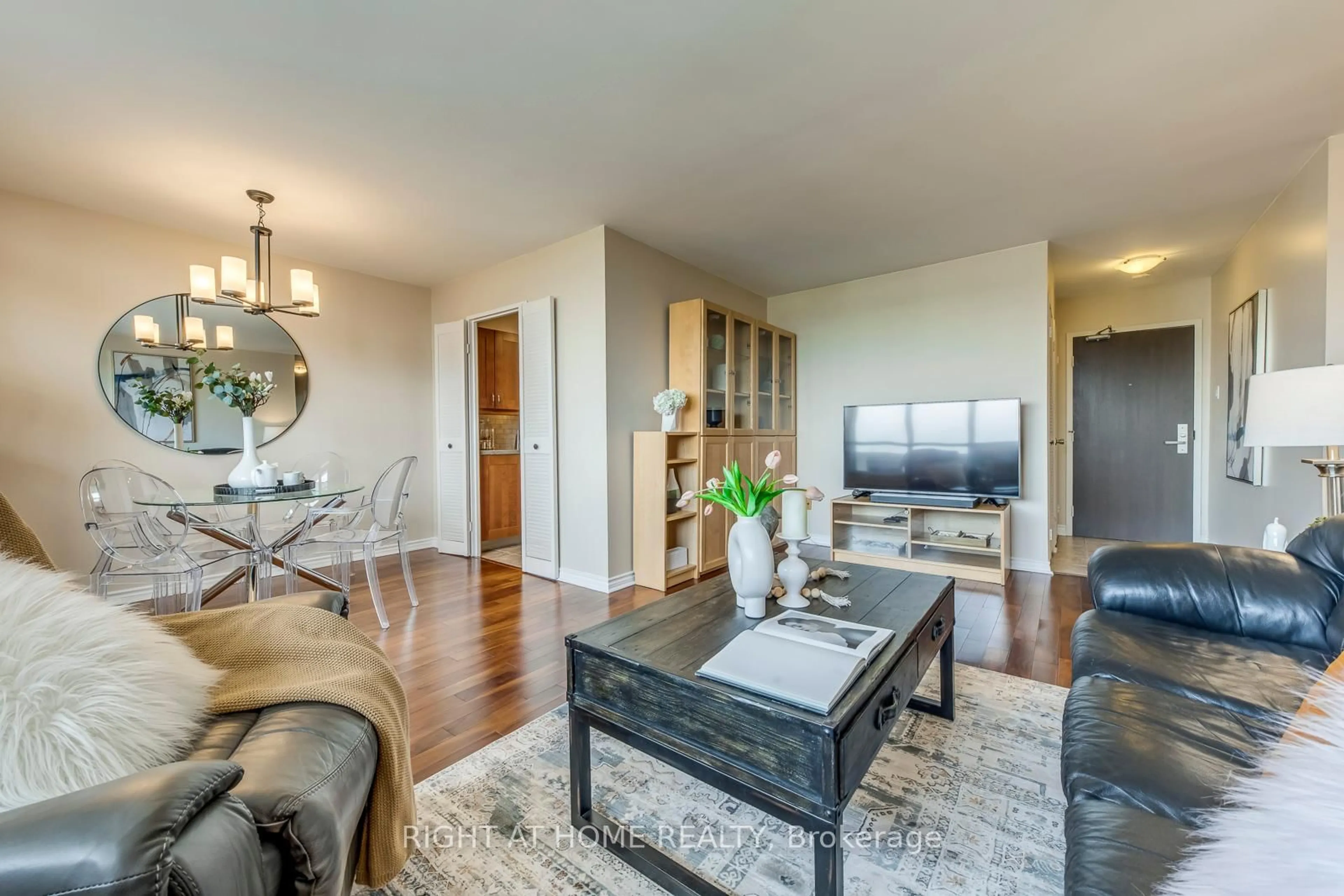 Living room with furniture, wood/laminate floor for 45 Southport St #PH11, Toronto Ontario M6S 3N5