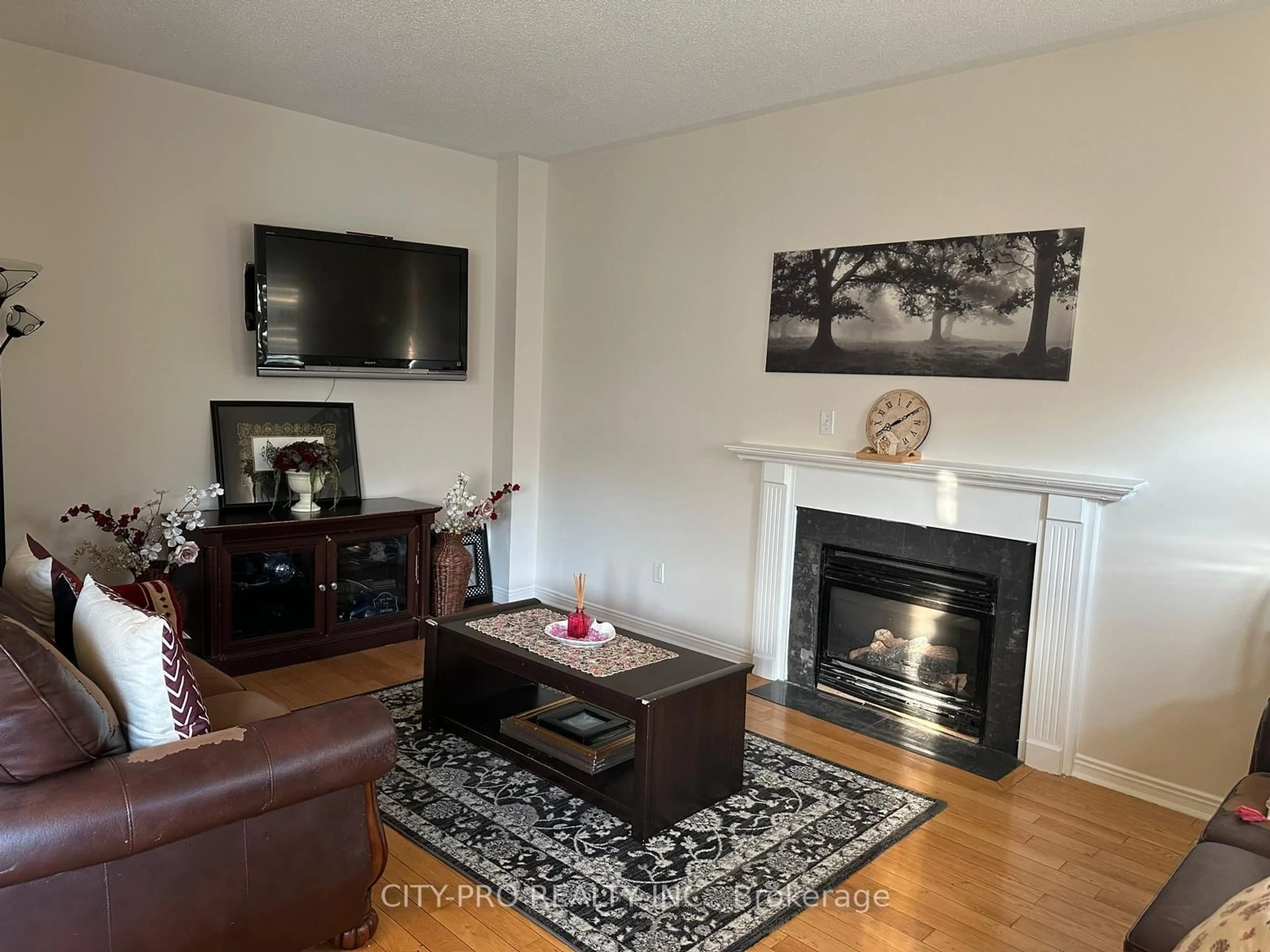 Living room with furniture, wood/laminate floor for 7302 Rosehurst Dr, Mississauga Ontario L5N 8H1