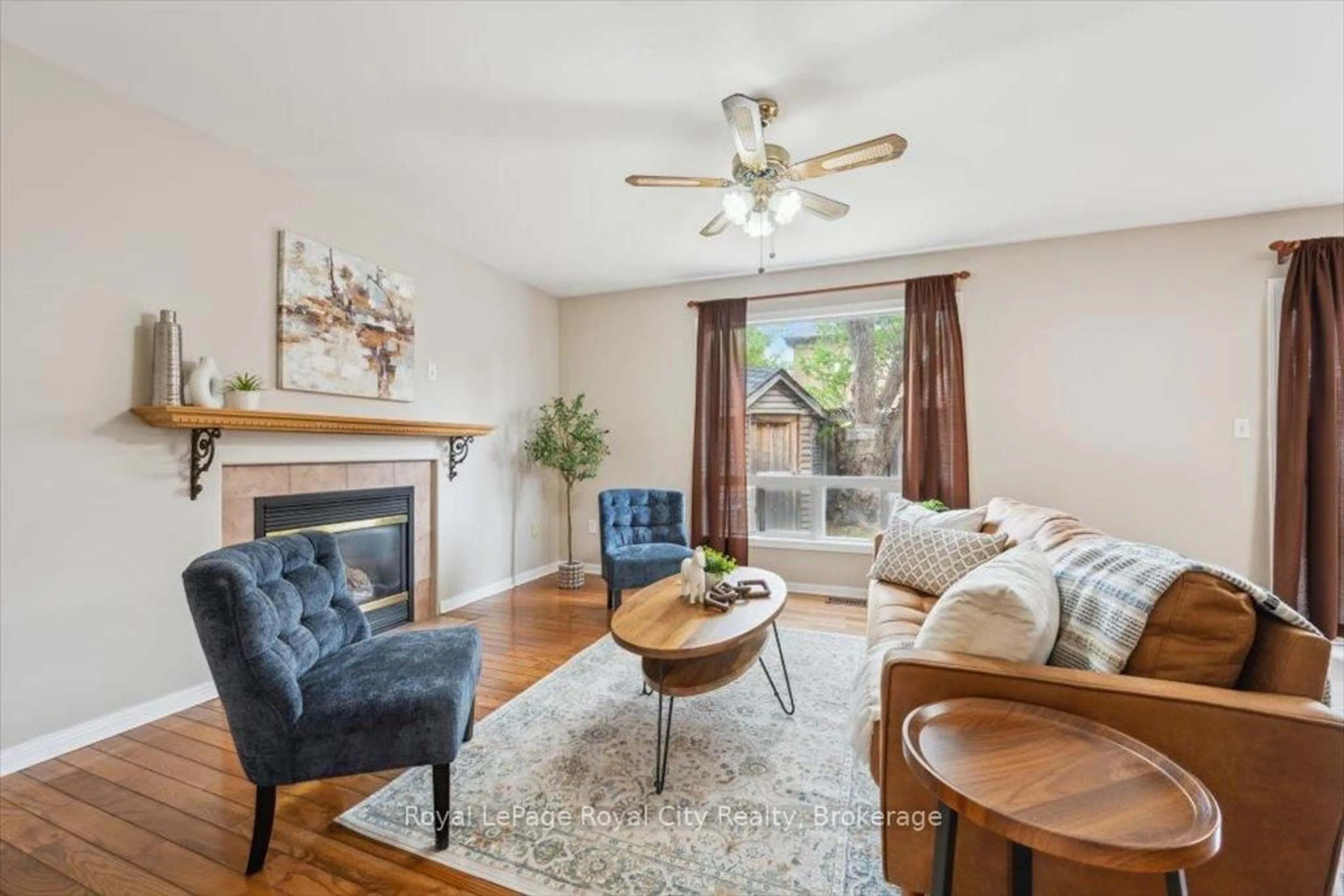 Living room with furniture, wood/laminate floor for 1617 Gowling Terr, Milton Ontario L9T 5J6