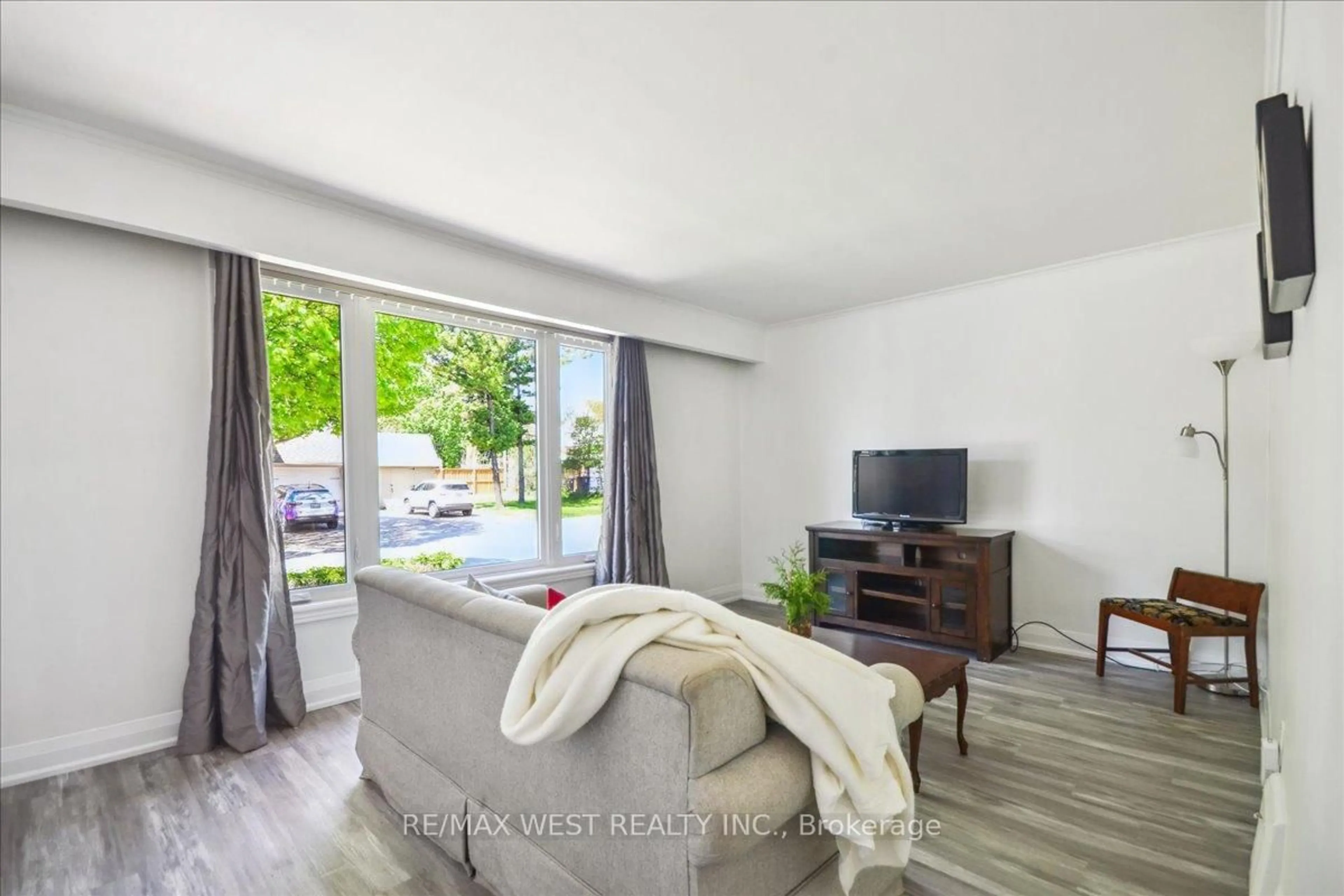 Living room with furniture, wood/laminate floor for 1 Huntsmoor Rd, Toronto Ontario M9W 3R4