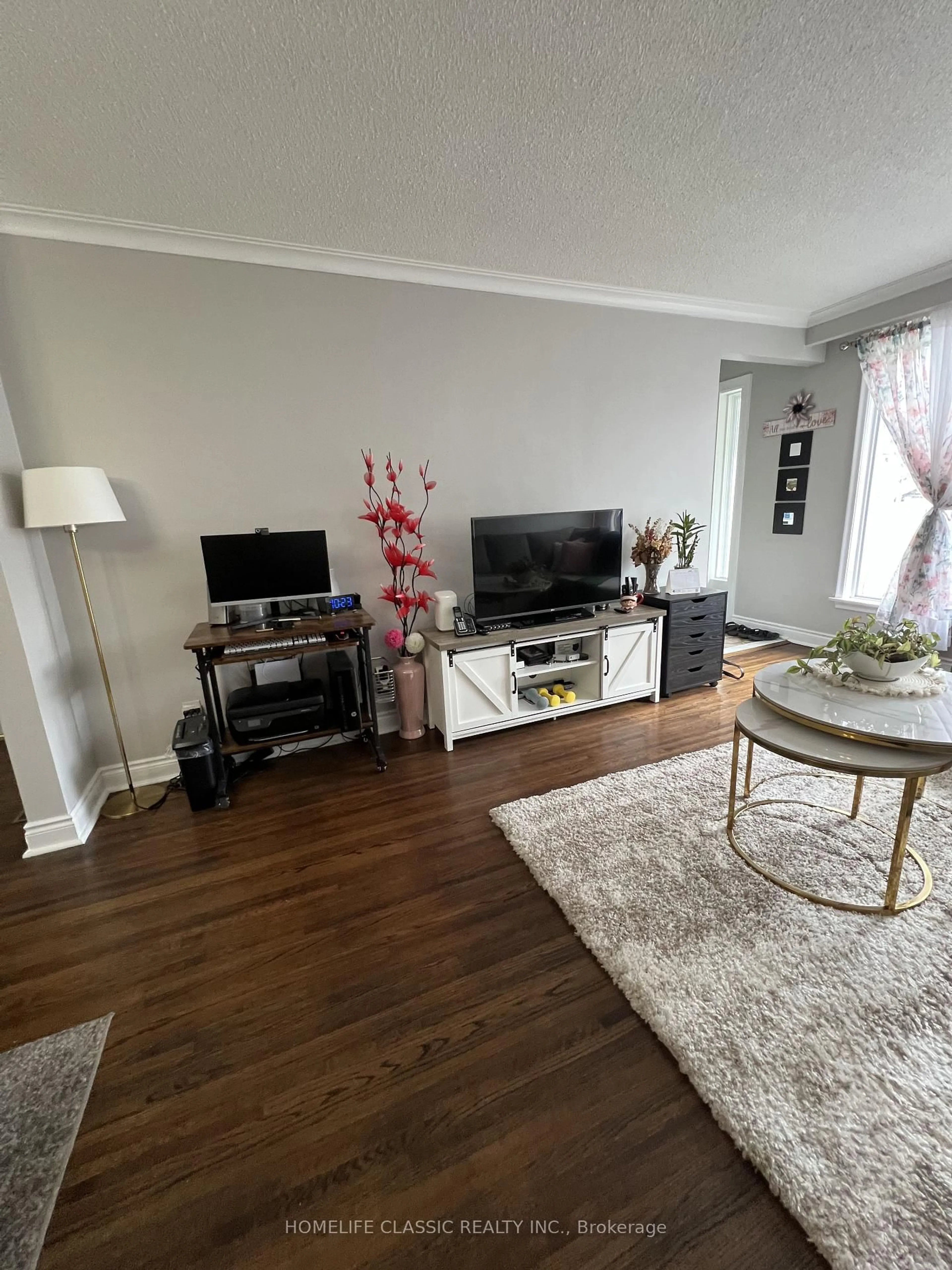Living room with furniture, wood/laminate floor for 19 Neames Cres, Toronto Ontario M3L 1K8