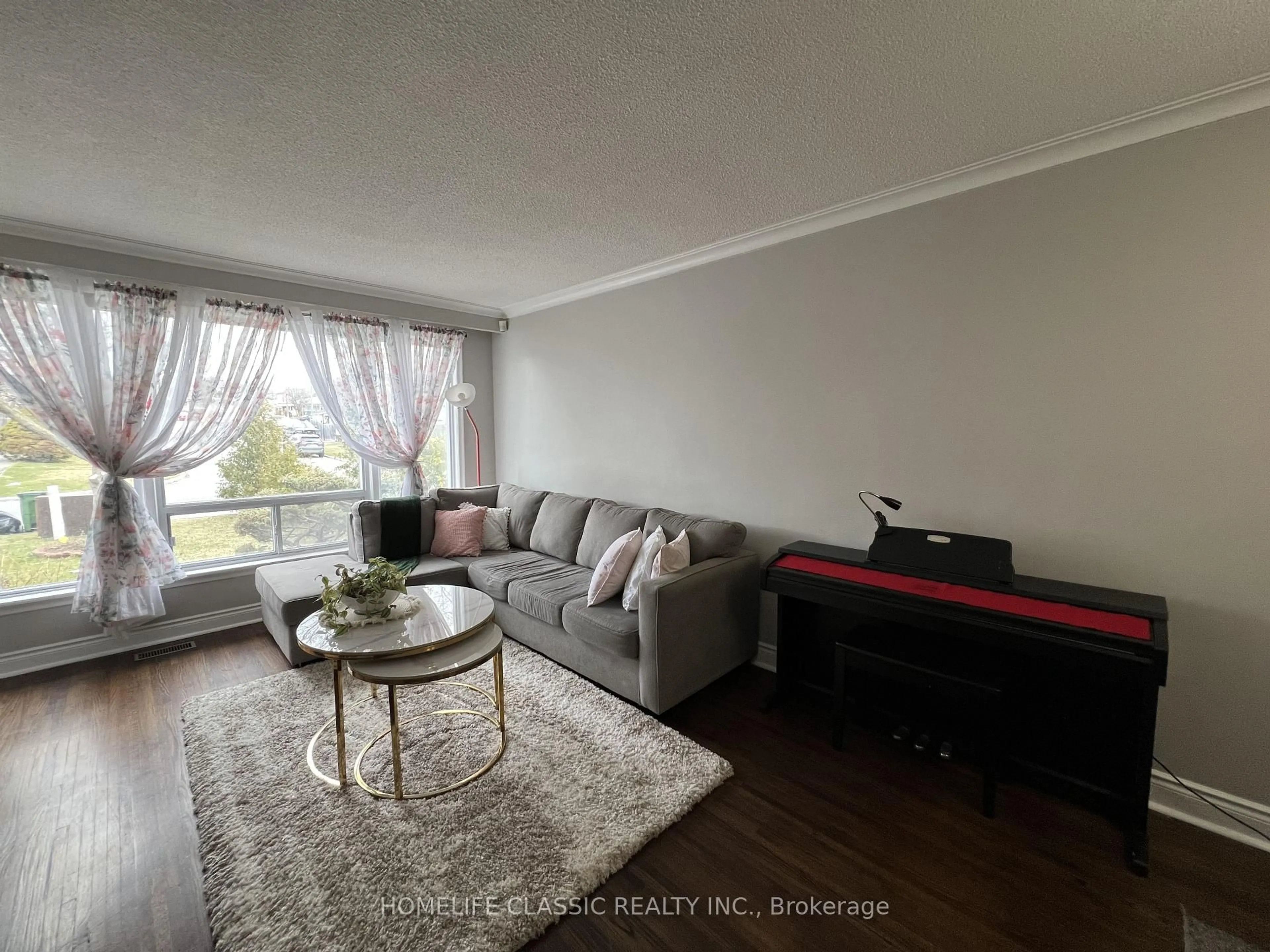 Living room with furniture, wood/laminate floor for 19 Neames Cres, Toronto Ontario M3L 1K8