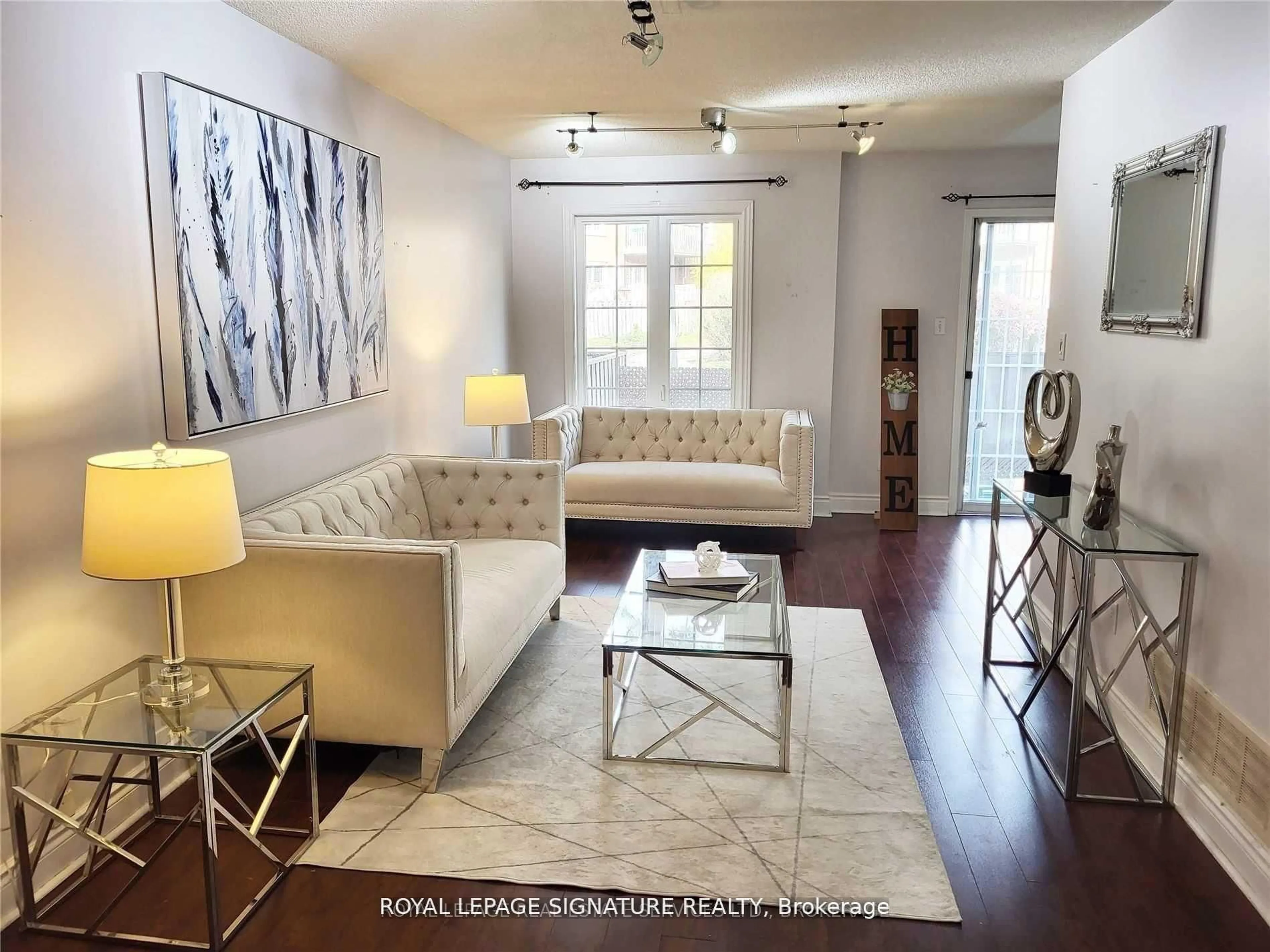 Living room with furniture, wood/laminate floor for 6950 Tenth Line #29, Mississauga Ontario L5N 6Y1