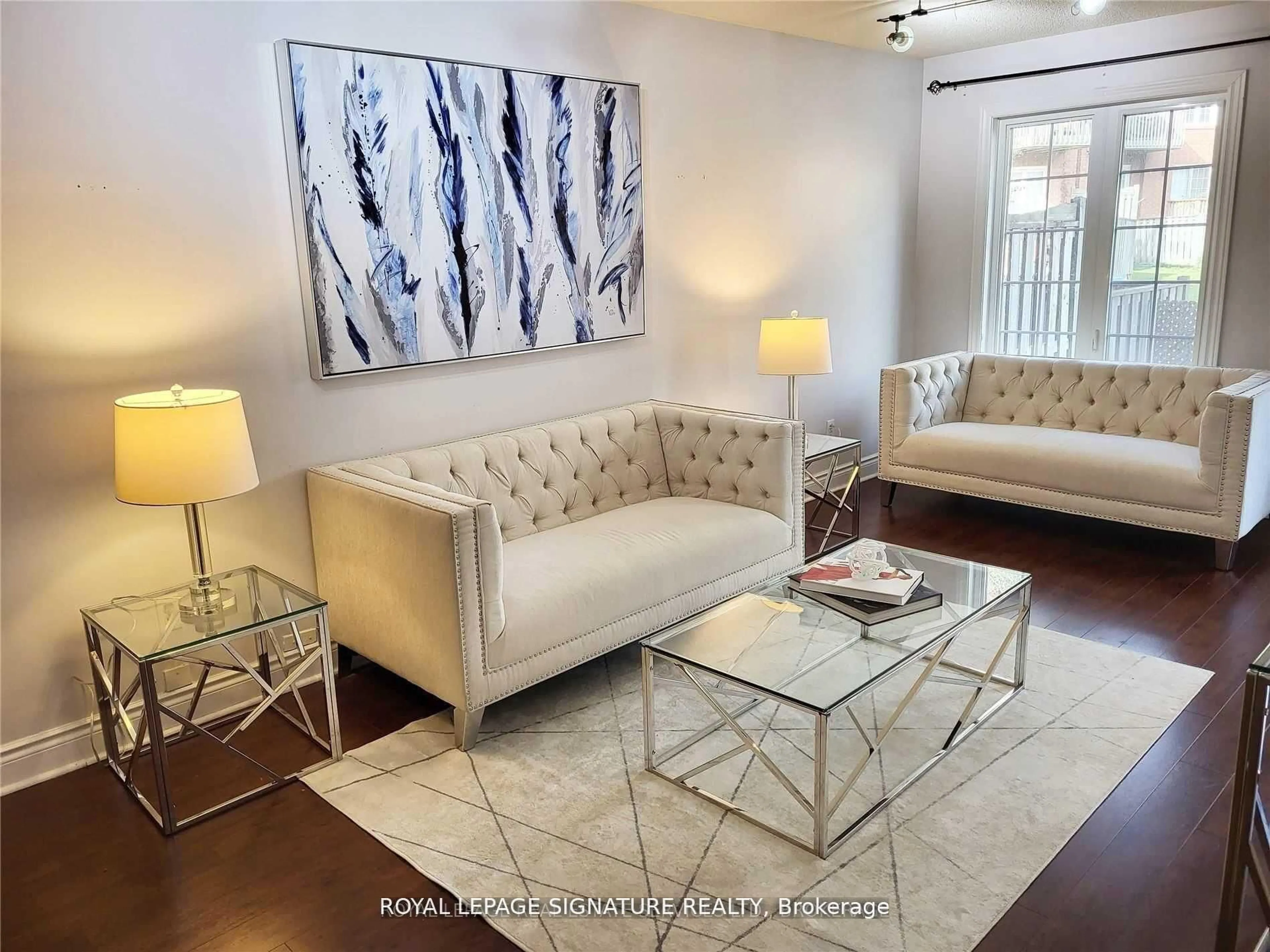 Living room with furniture, wood/laminate floor for 6950 Tenth Line #29, Mississauga Ontario L5N 6Y1