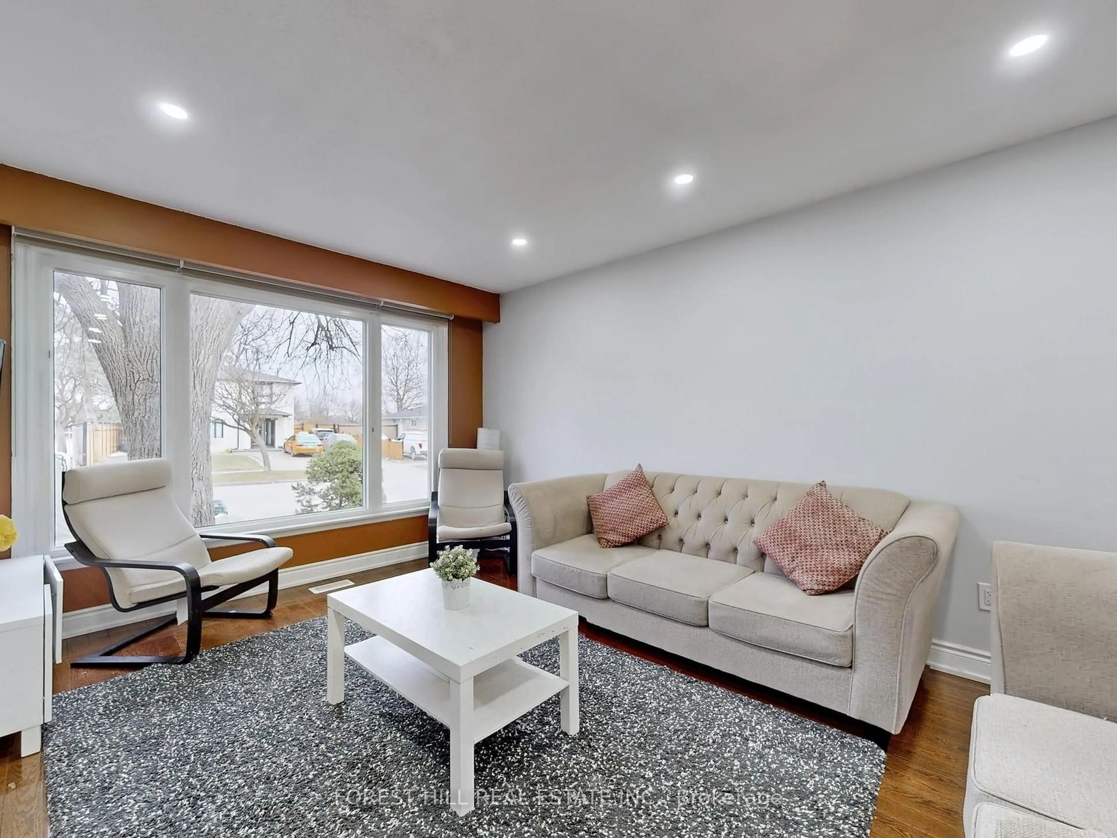 Living room with furniture, wood/laminate floor for 44 Herkley Dr, Brampton Ontario L6V 2E8