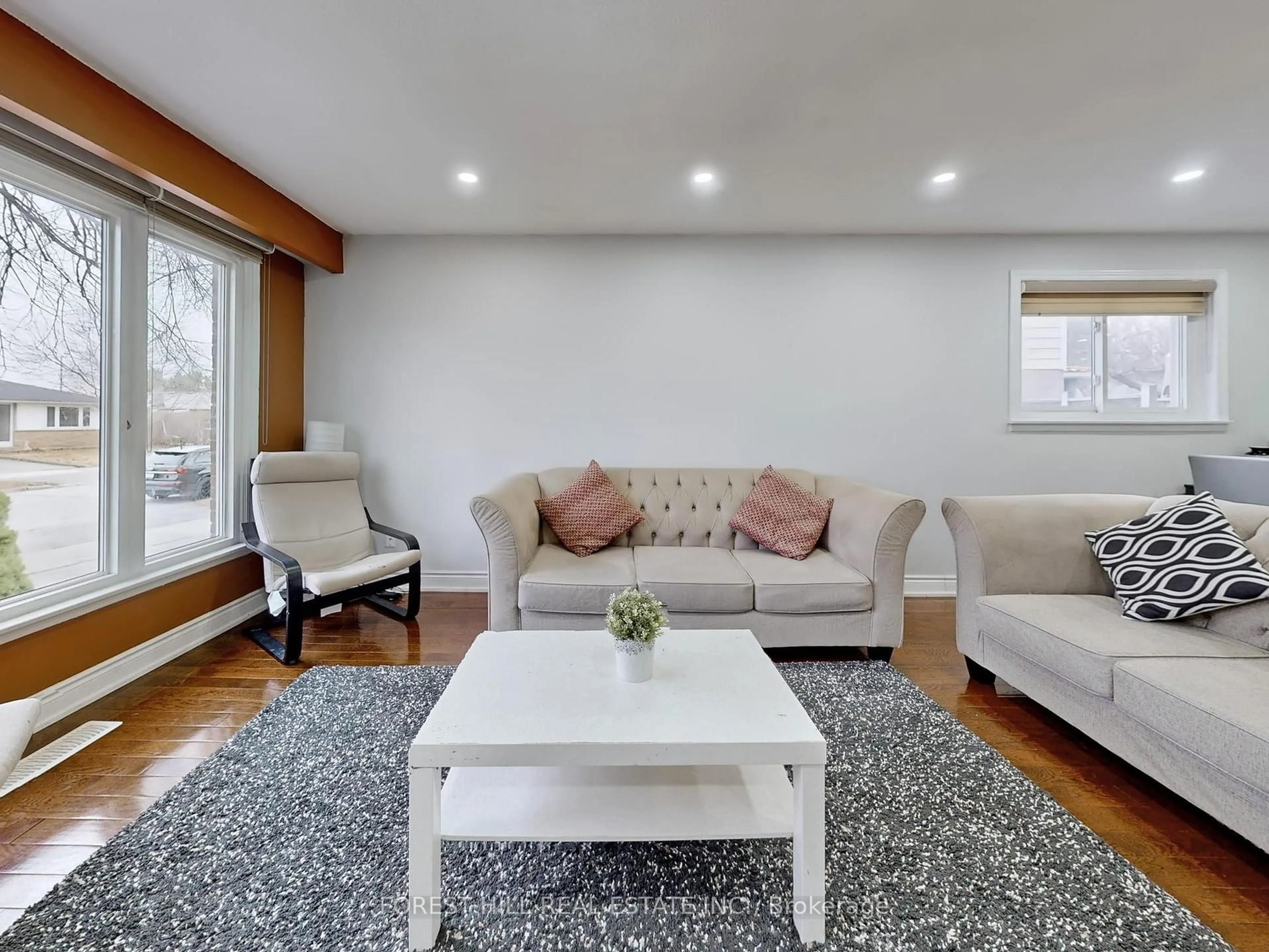 Living room with furniture, wood/laminate floor for 44 Herkley Dr, Brampton Ontario L6V 2E8