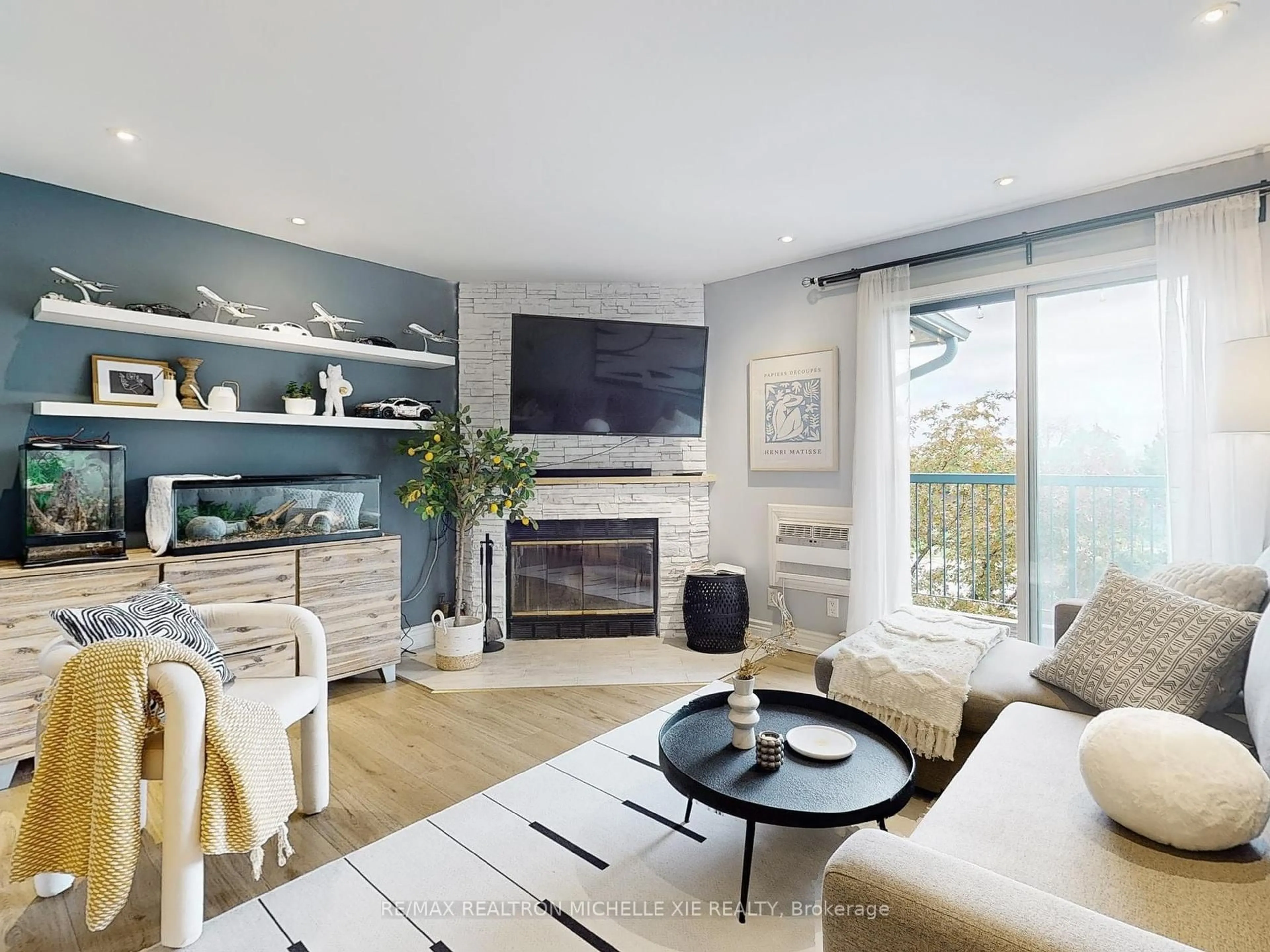 Living room with furniture, wood/laminate floor for 65 Trailwood Dr #133, Mississauga Ontario L4Z 3L1