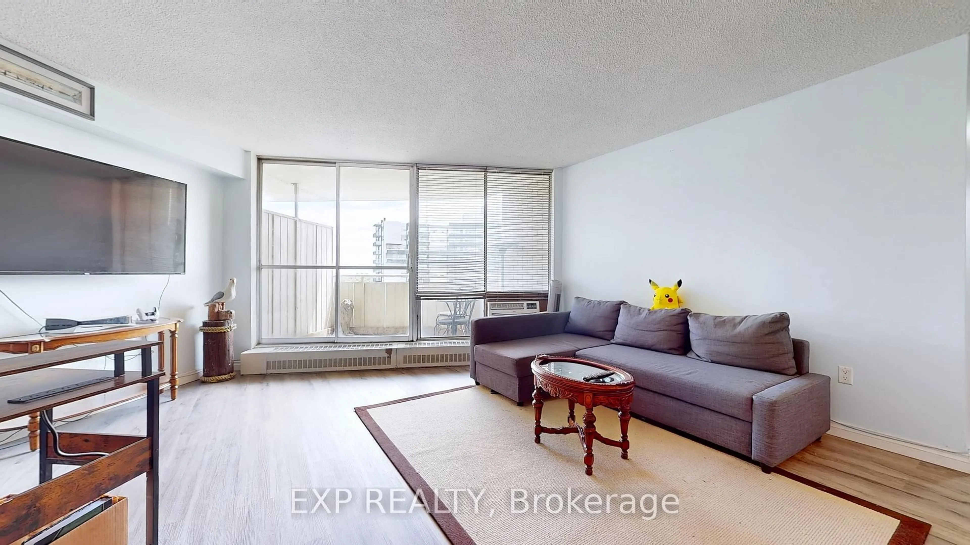 Living room with furniture, wood/laminate floor for 330 Dixon Rd #1007, Toronto Ontario M9R 1S9