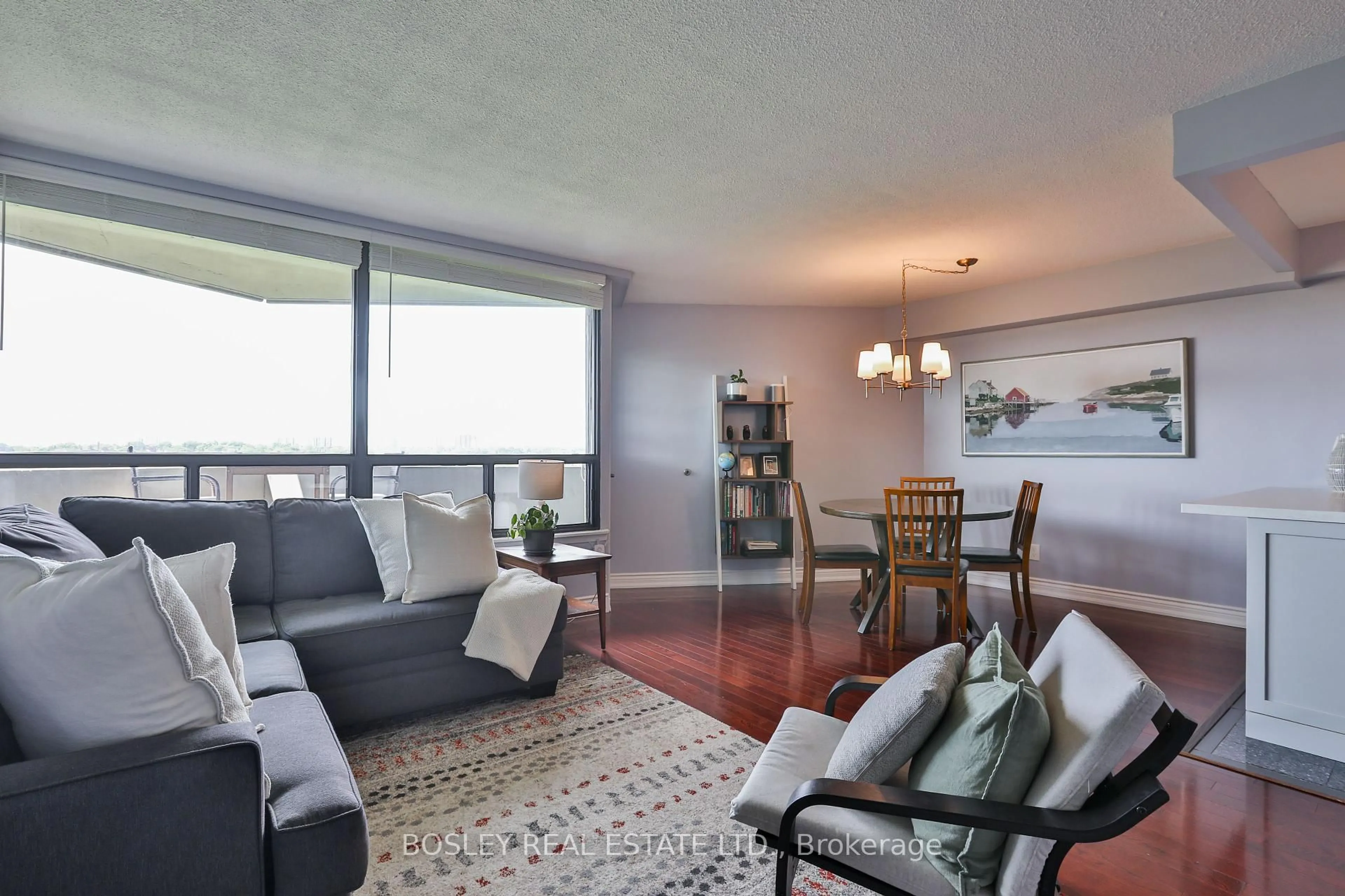 Living room with furniture, wood/laminate floor for 284 Mill Rd #C15, Toronto Ontario M9C 4W6
