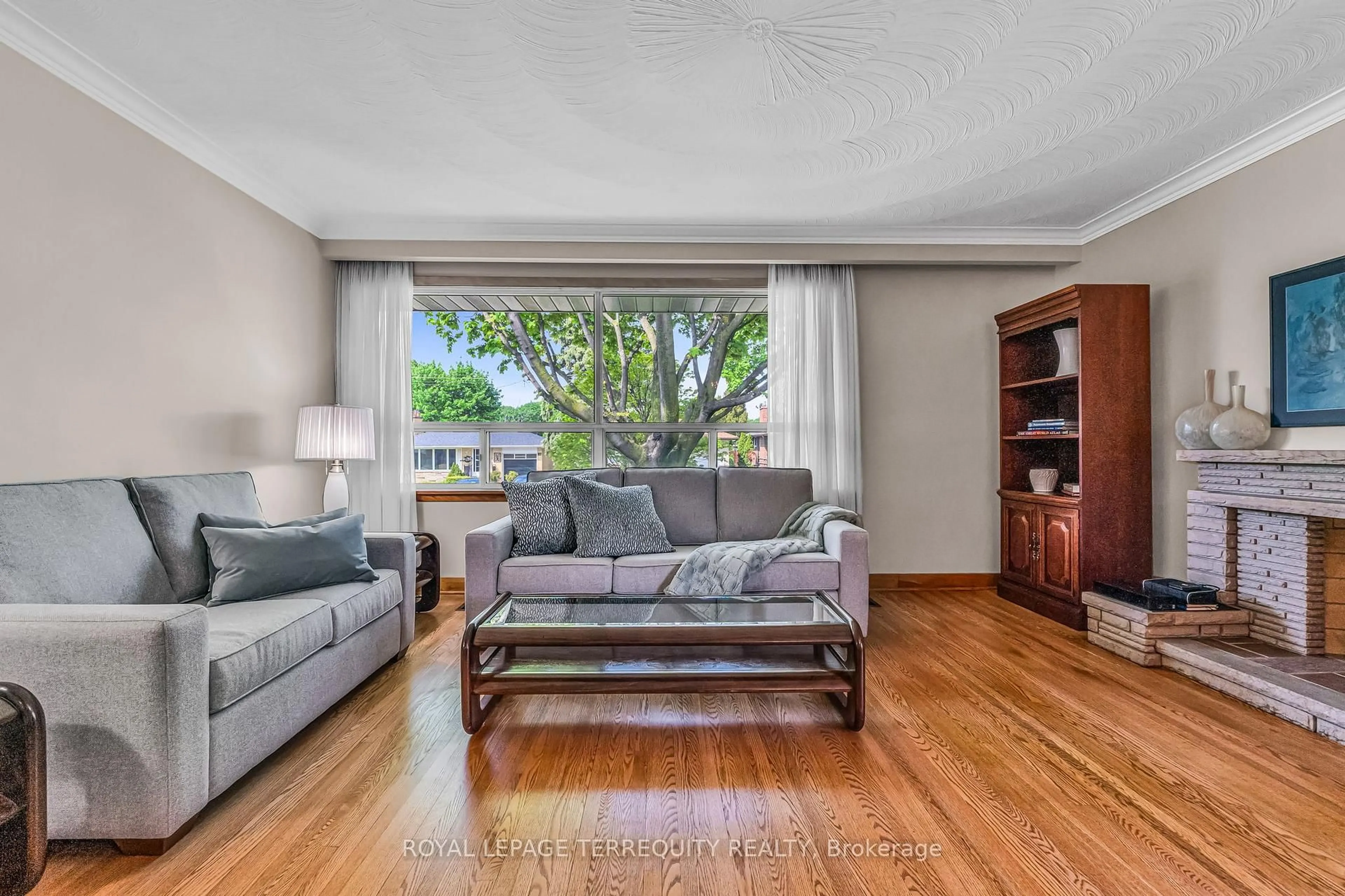 Living room with furniture, wood/laminate floor for 16 Rowse Cres, Toronto Ontario M9P 3L5