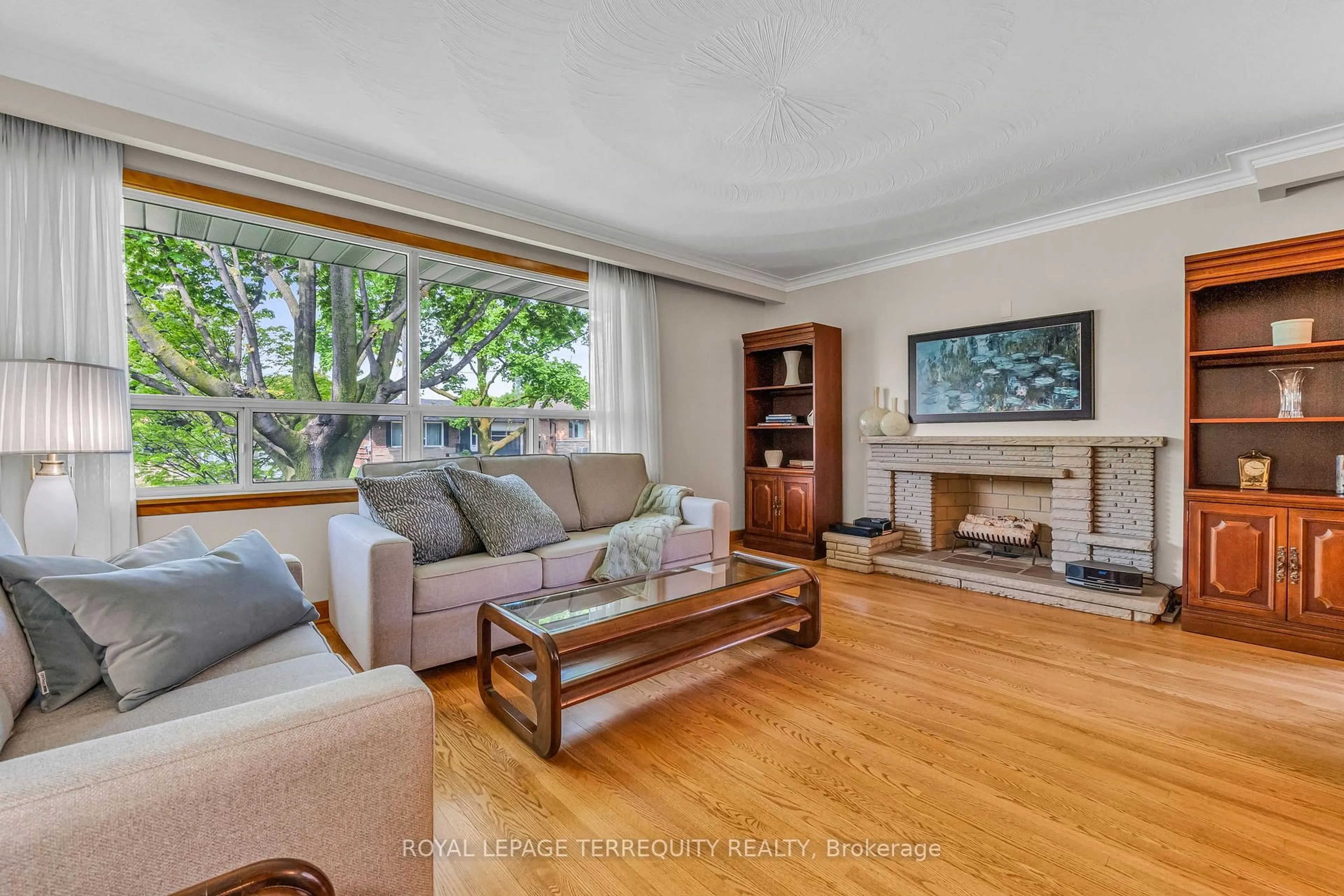 Living room with furniture, wood/laminate floor for 16 Rowse Cres, Toronto Ontario M9P 3L5