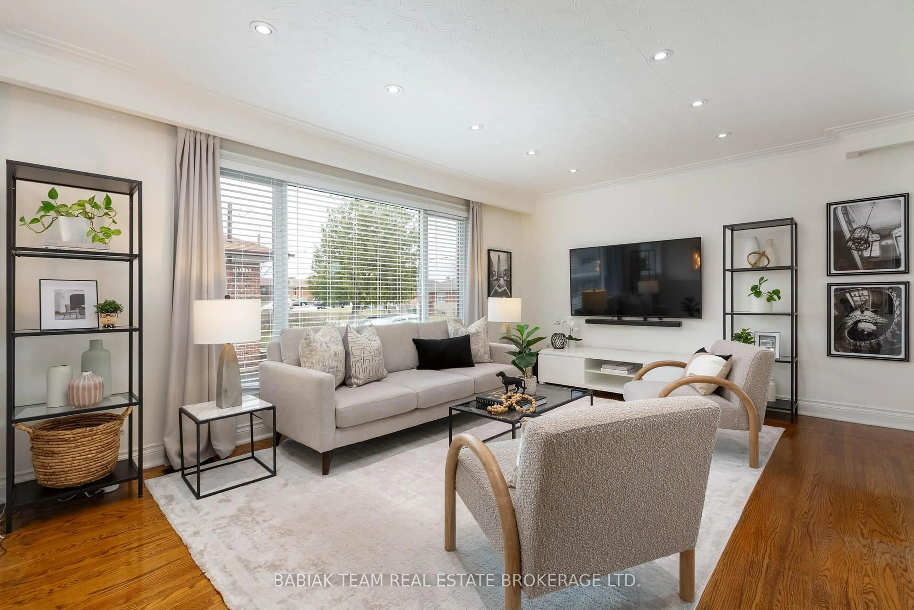 Living room with furniture, wood/laminate floor for 62 Burr Ave, Toronto Ontario M6L 1T8