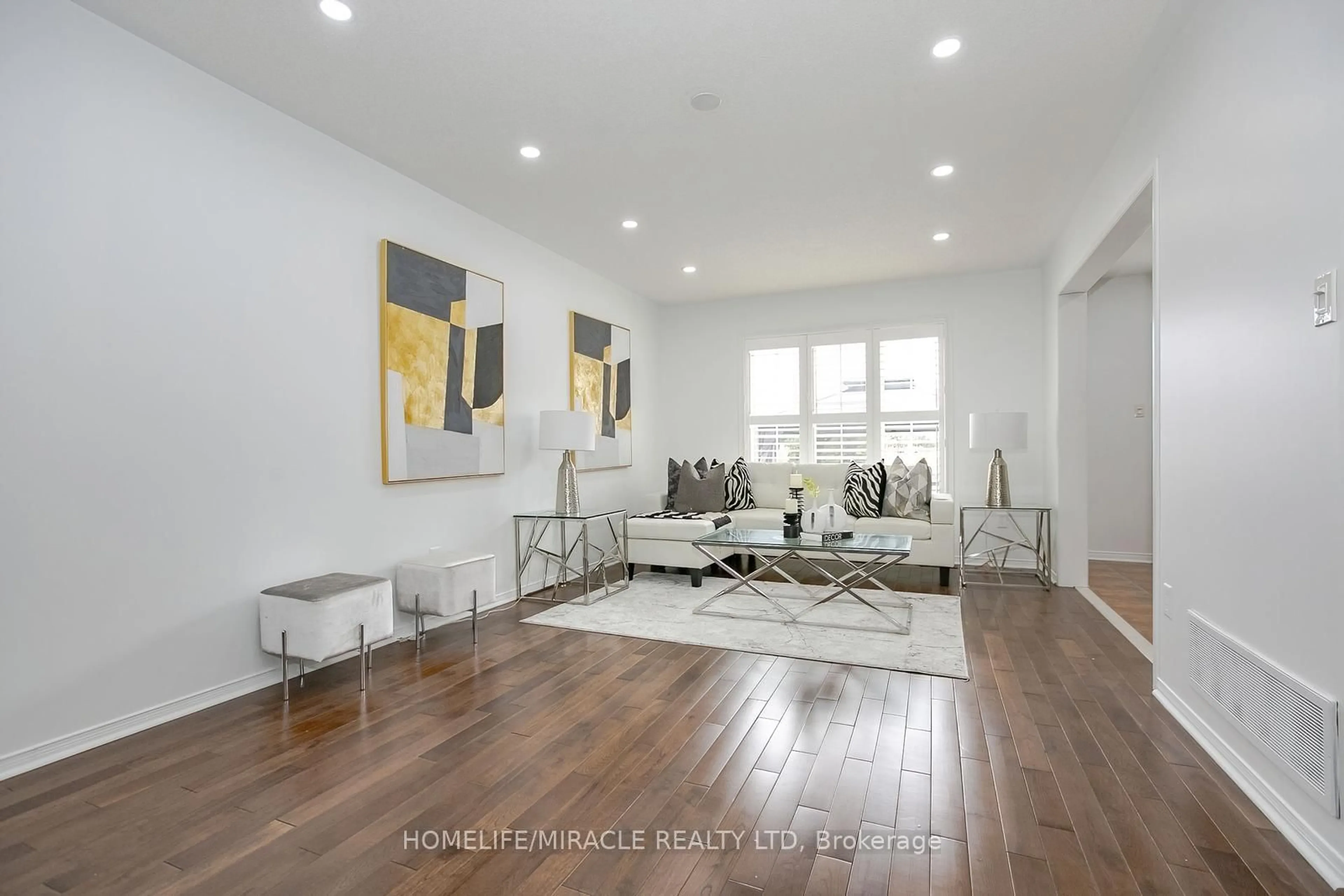 Living room with furniture, wood/laminate floor for 182 Bufford Dr, Brampton Ontario L6Y 3N3