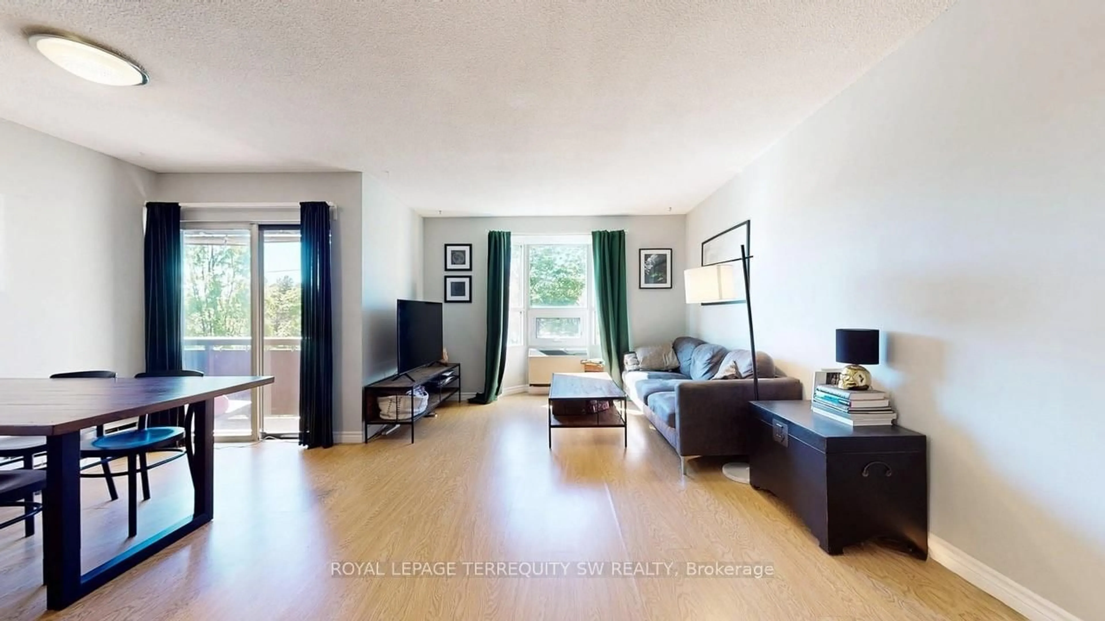 Living room with furniture, wood/laminate floor for 3835 Lake Shore Blvd #210, Toronto Ontario M8W 1R2