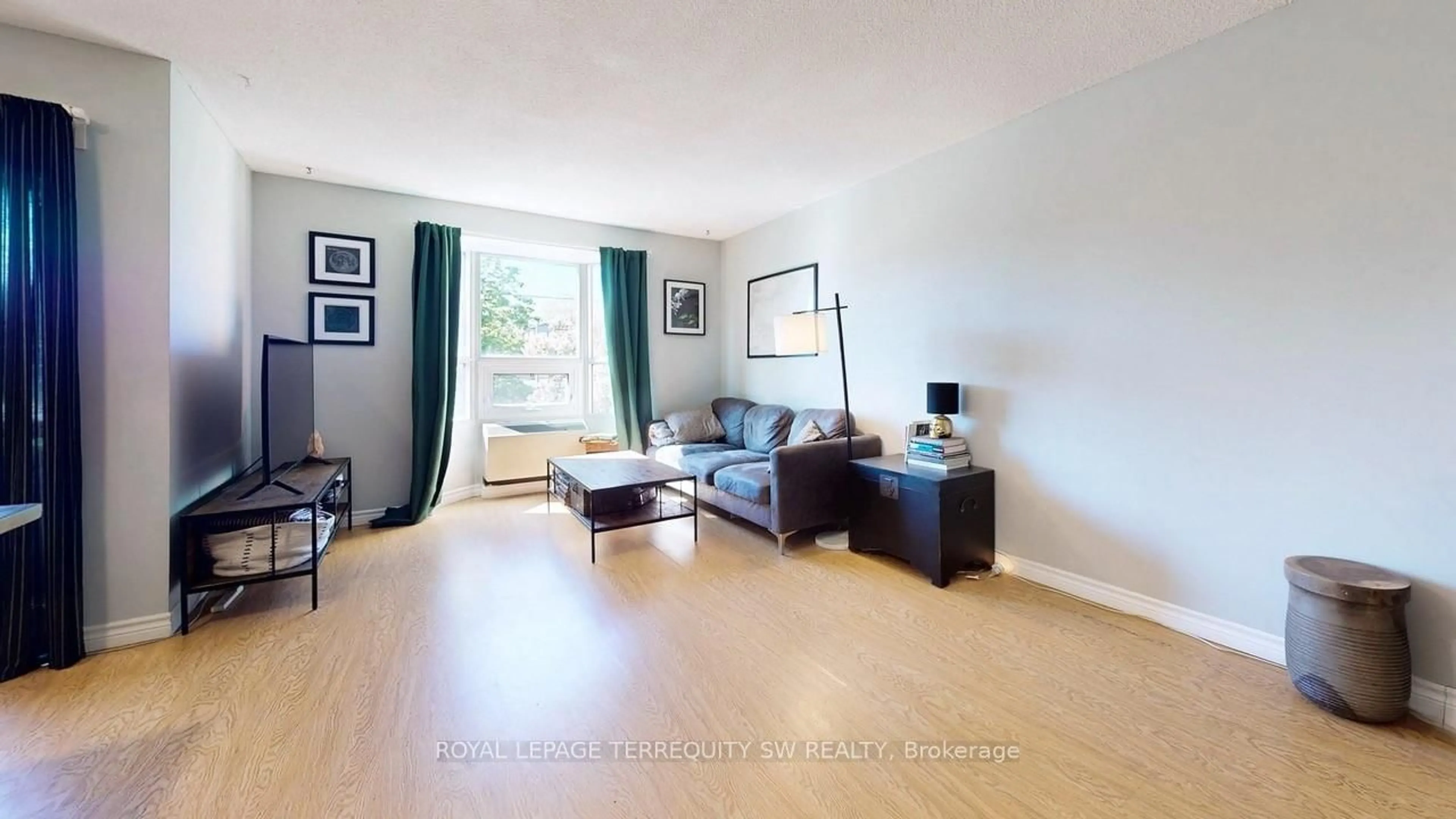 Living room with furniture, wood/laminate floor for 3835 Lake Shore Blvd #210, Toronto Ontario M8W 1R2
