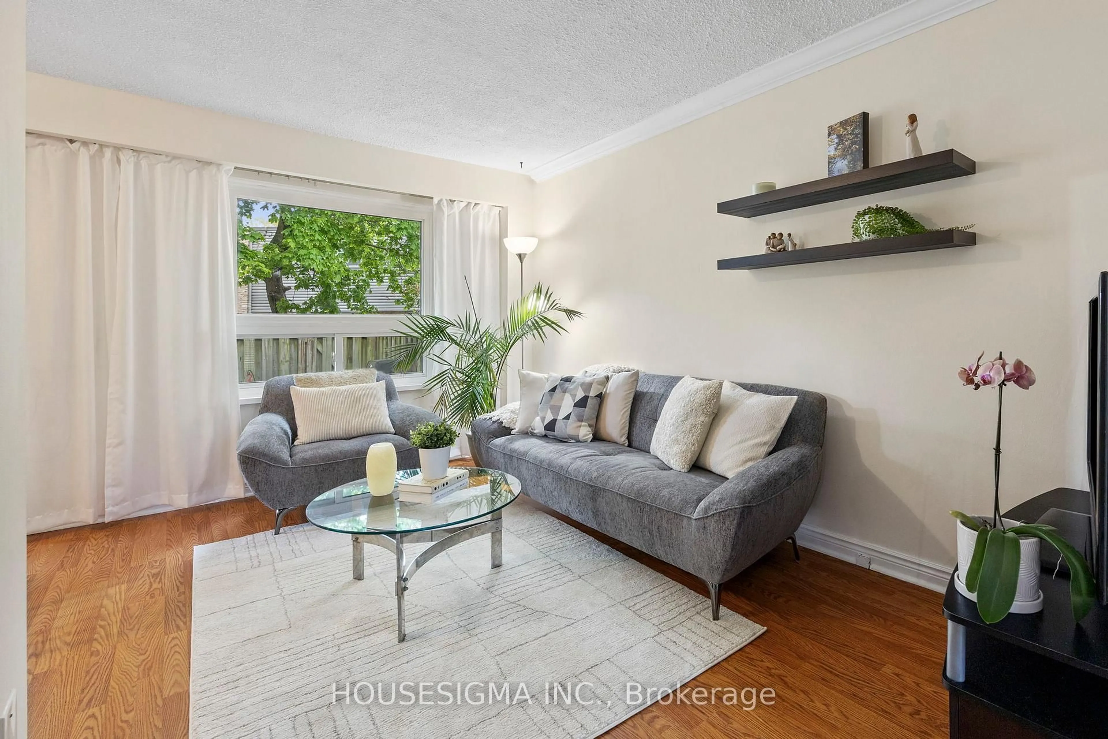 Living room with furniture, wood/laminate floor for 2315 Bromsgrove Rd #101, Mississauga Ontario L5J 4A6