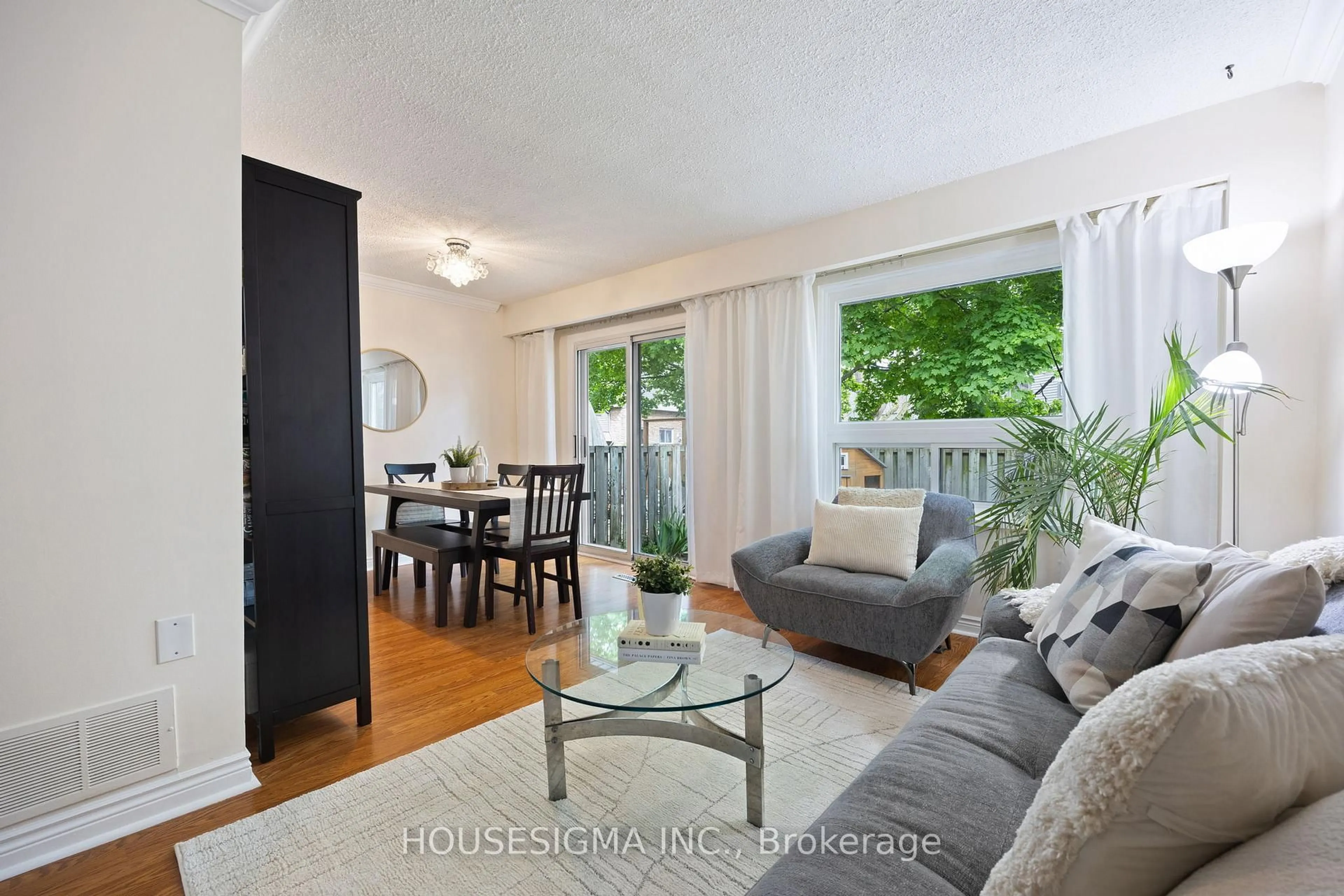 Living room with furniture, wood/laminate floor for 2315 Bromsgrove Rd #101, Mississauga Ontario L5J 4A6