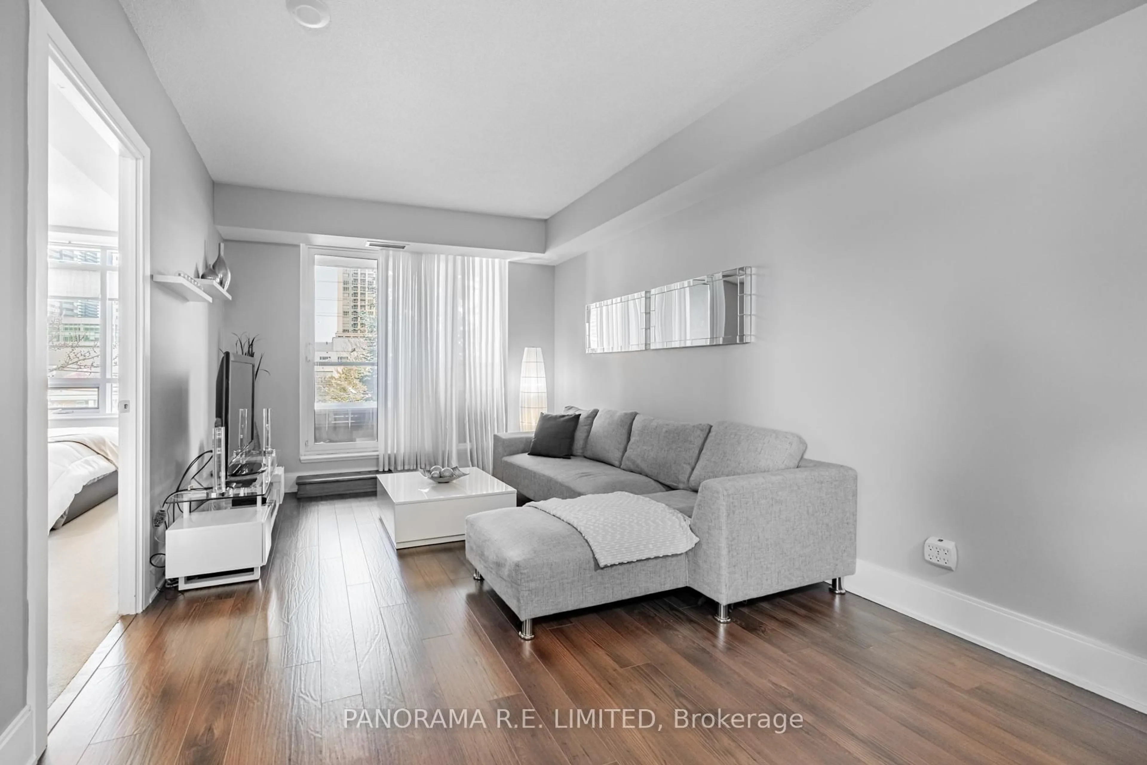 Living room with furniture, wood/laminate floor for 330 Burnhamthorpe Rd #203, Mississauga Ontario L5B 0E1