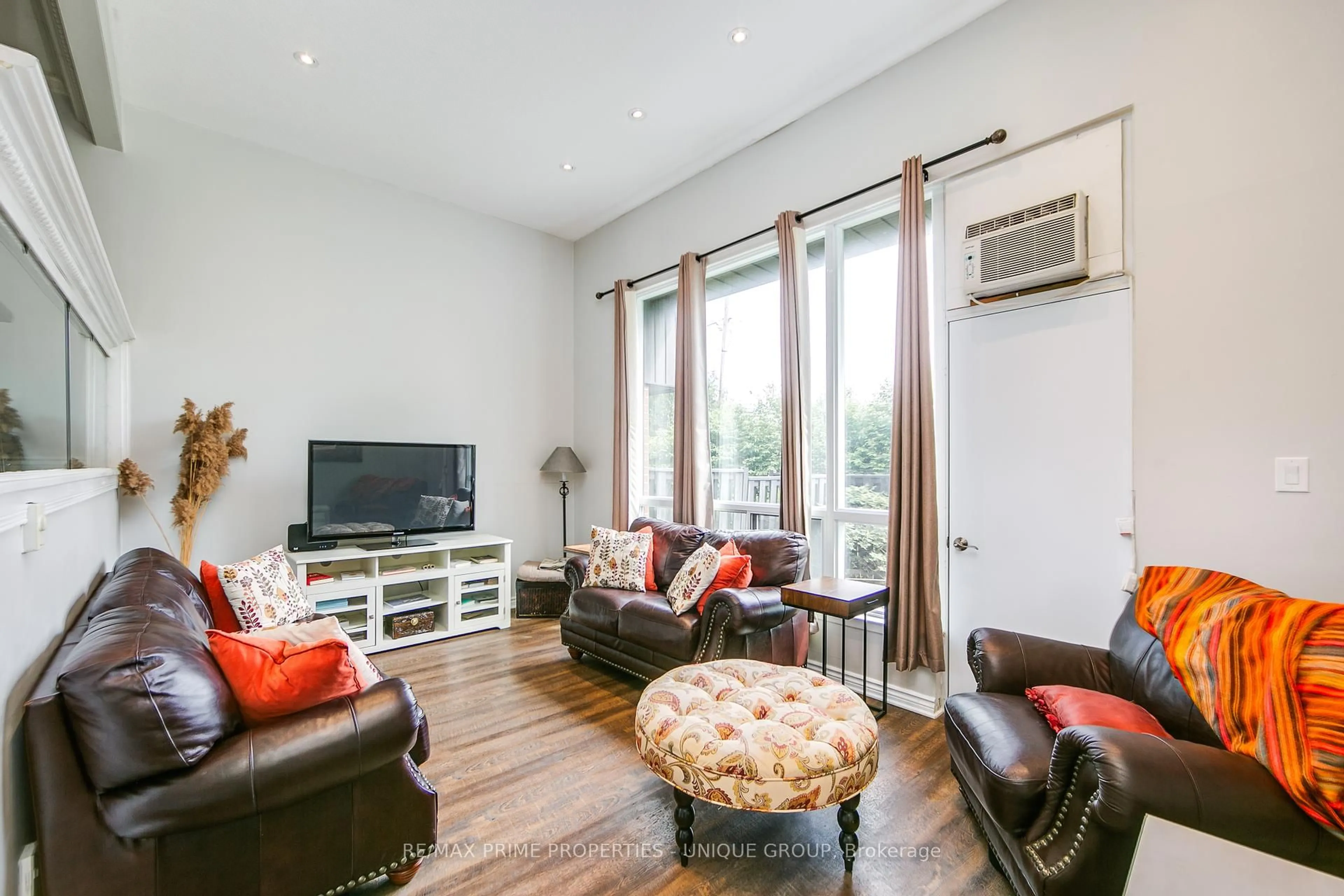 Living room with furniture, wood/laminate floor for 104 Darras Crt, Brampton Ontario L6T 1W7