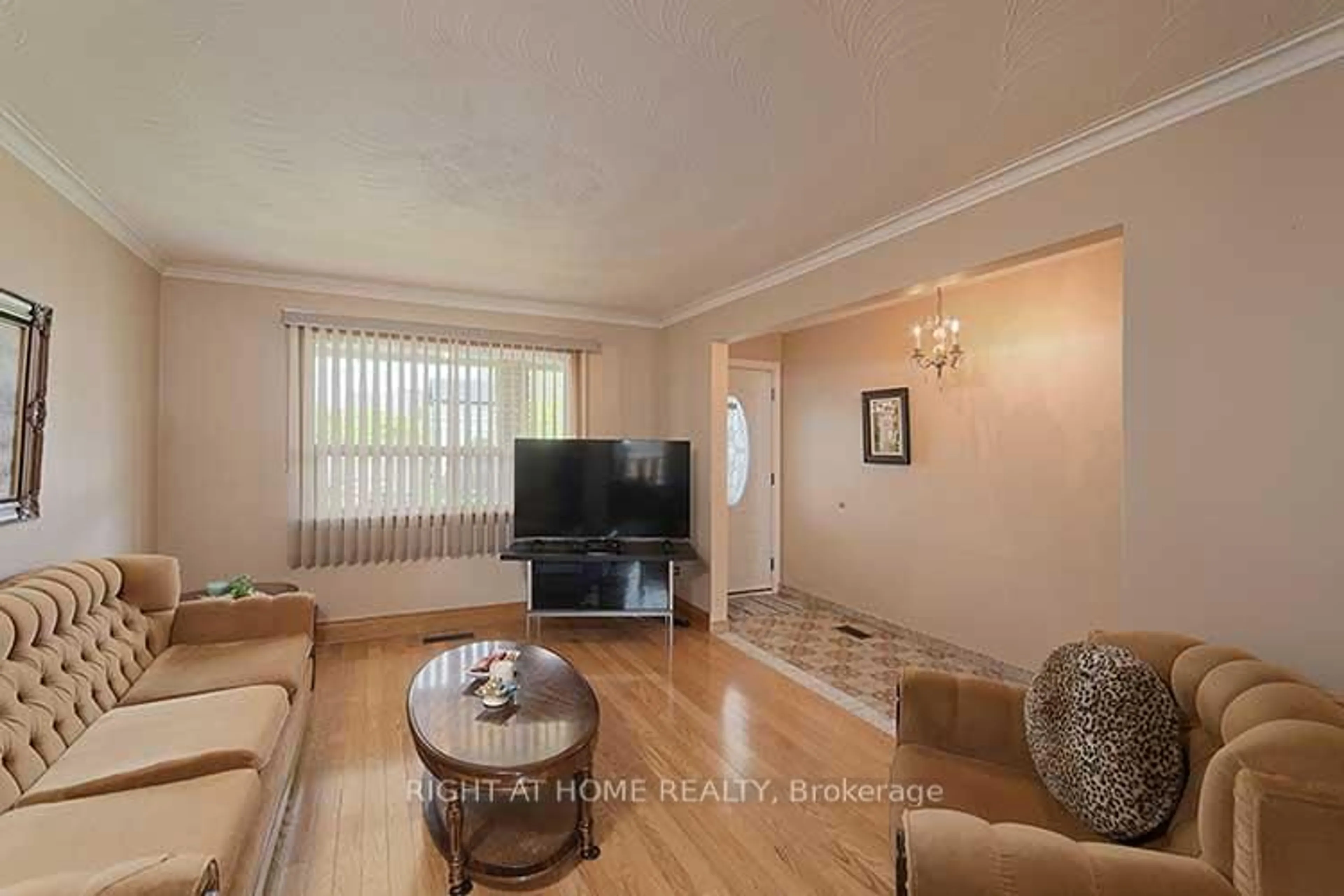 Living room with furniture, wood/laminate floor for 409 Rustic Rd, Toronto Ontario M6L 1W8