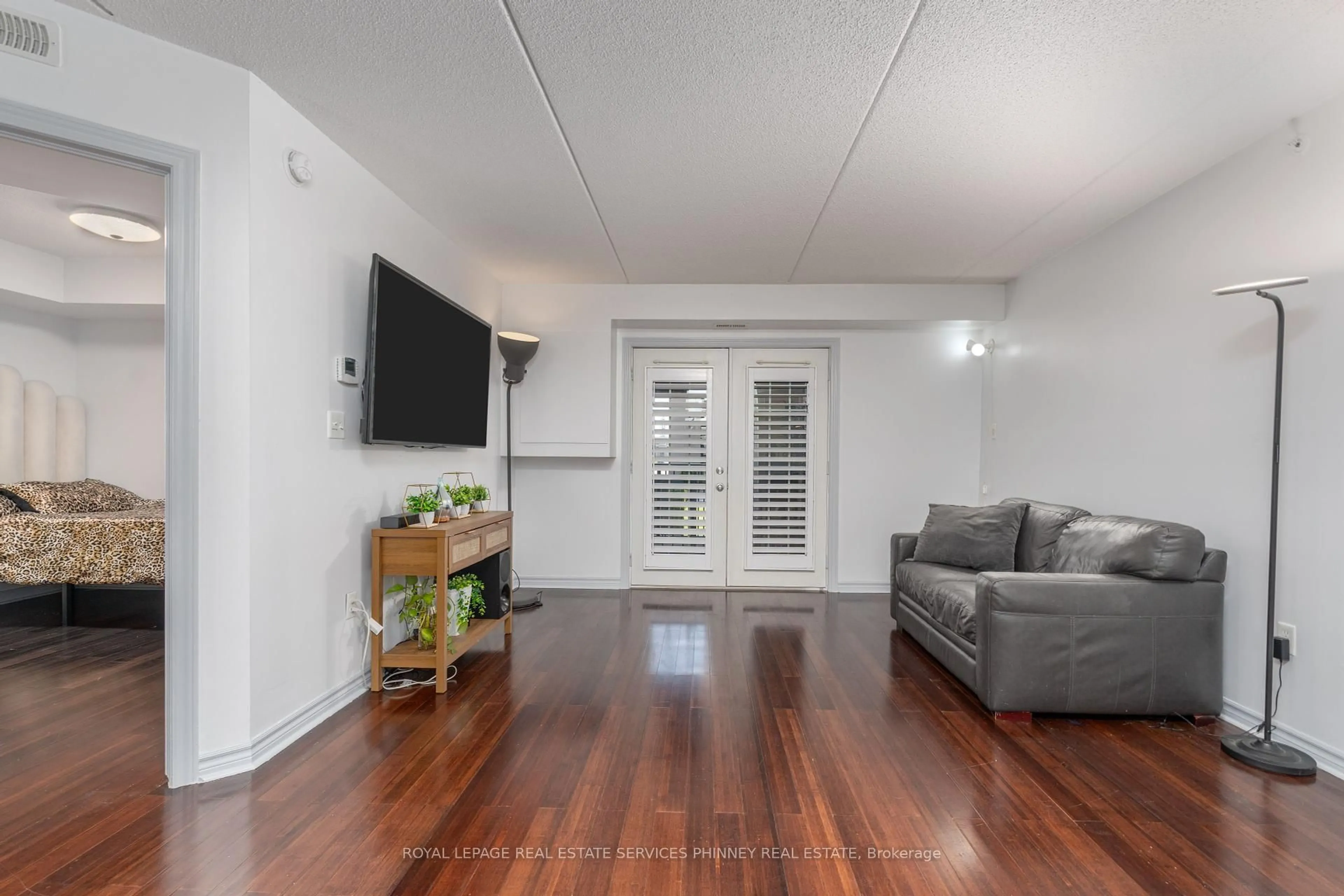 Living room with furniture, wood/laminate floor for 1350 Main St #208, Milton Ontario L9T 7S7