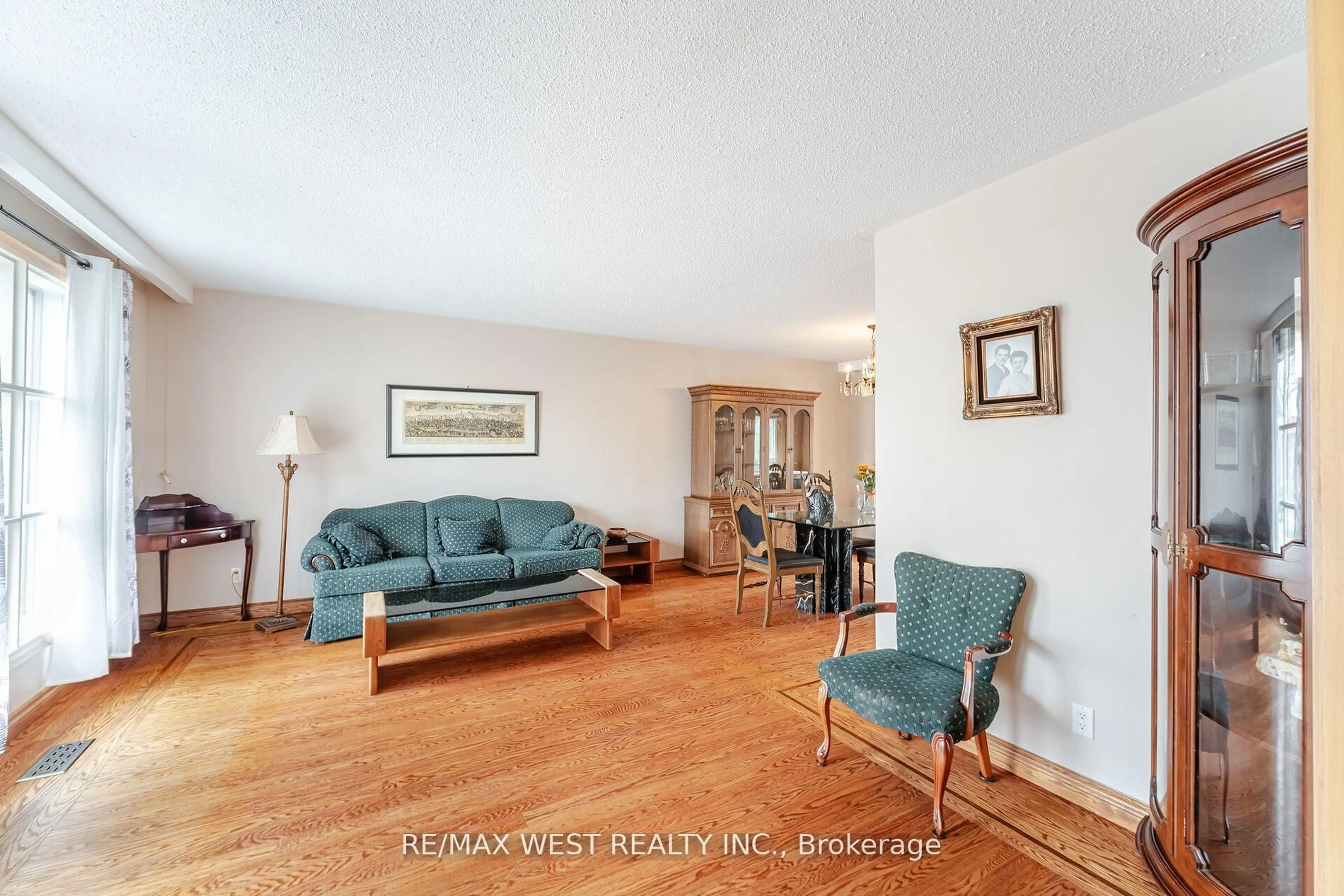 Living room with furniture, wood/laminate floor for 94 Windhill Cres, Toronto Ontario M9M 1Y4