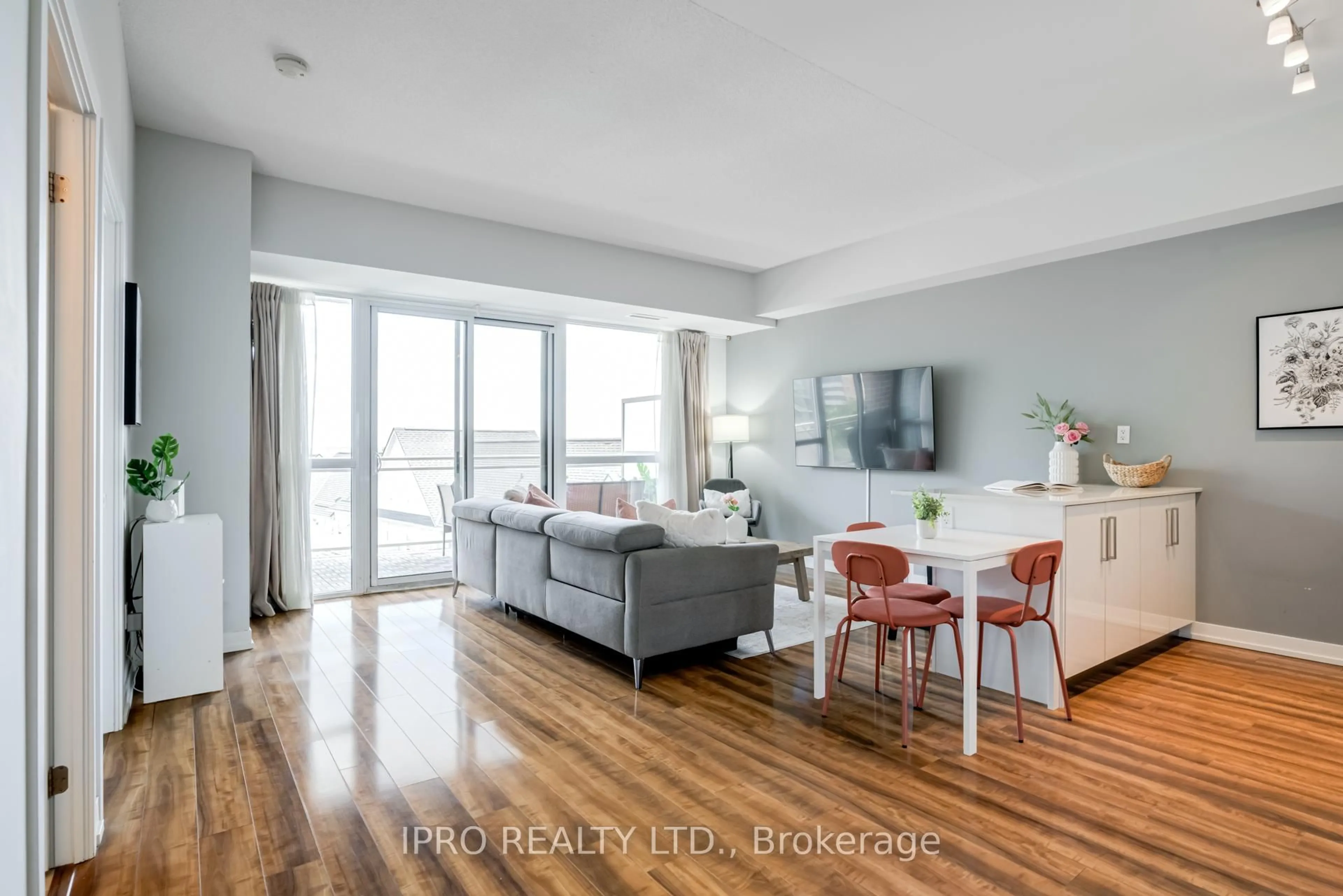 Living room with furniture, wood/laminate floor for 5101 Dundas St #406, Toronto Ontario M9A 5G8