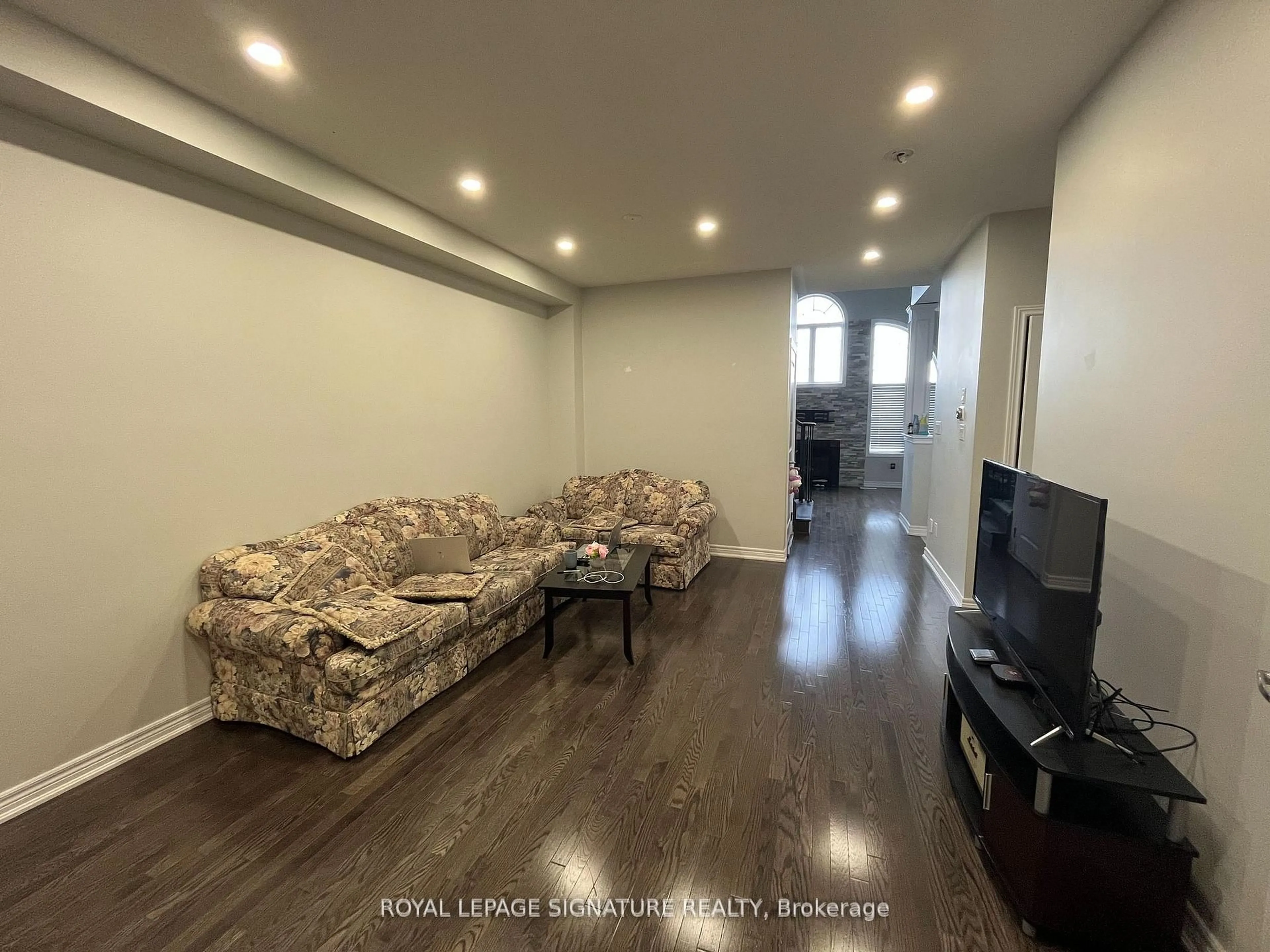 Living room with furniture, wood/laminate floor for 20 Naperton Dr, Brampton Ontario L6R 0Z5