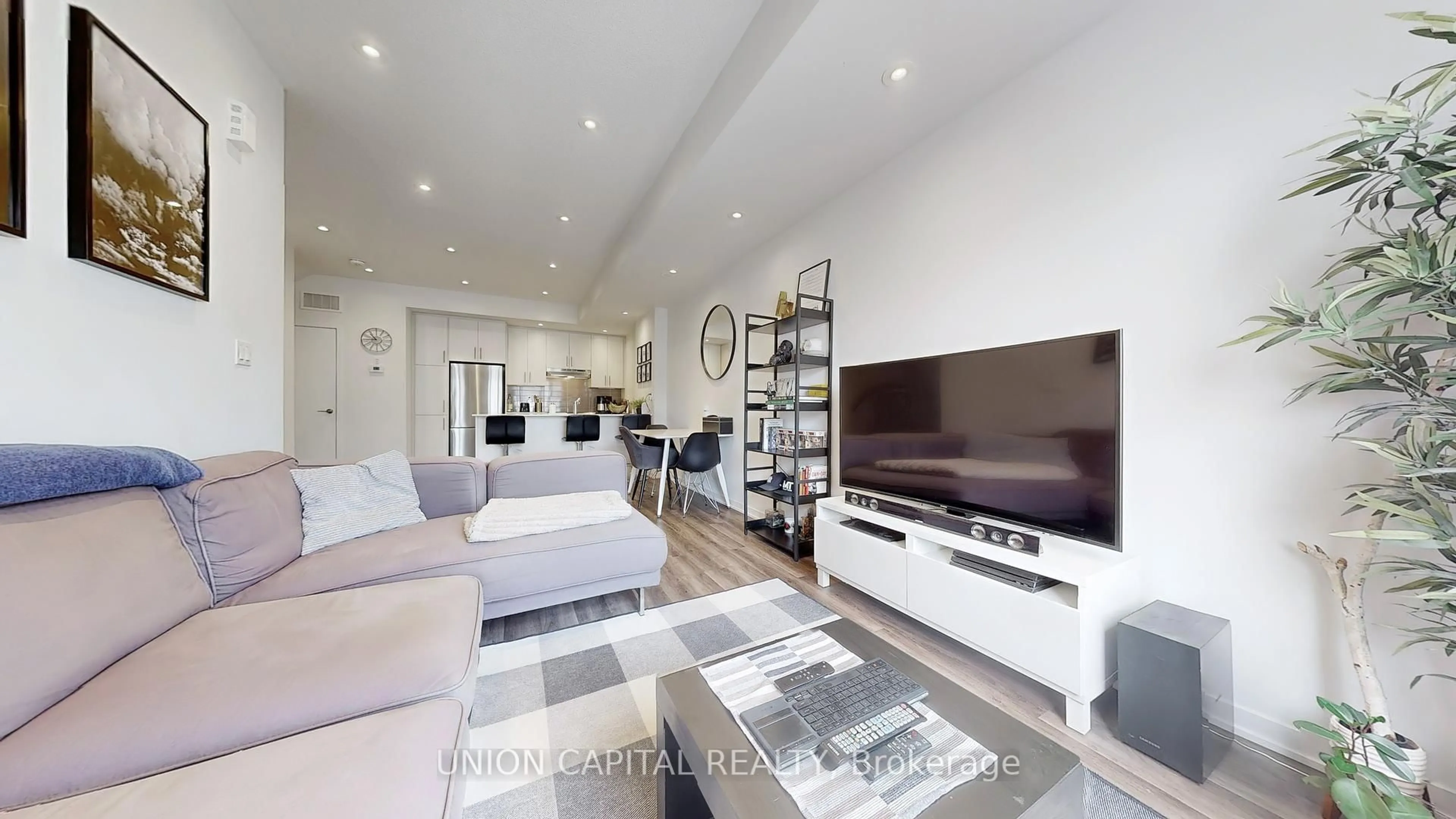 Living room with furniture, wood/laminate floor for 15 William Jackson Way #23, Toronto Ontario M8V 0J8