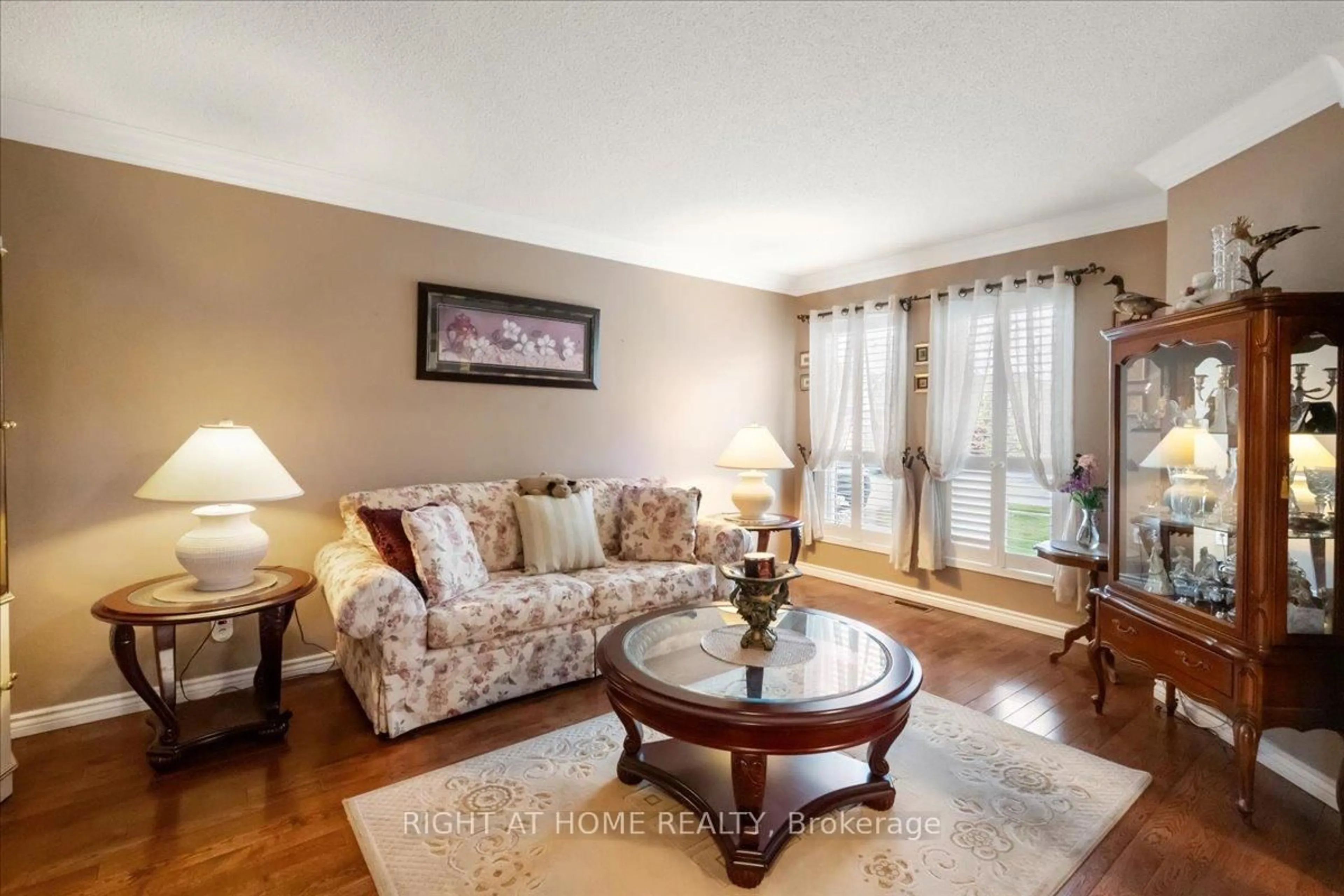 Living room with furniture, wood/laminate floor for 24 Suncrest Dr, Brampton Ontario L6X 4L5