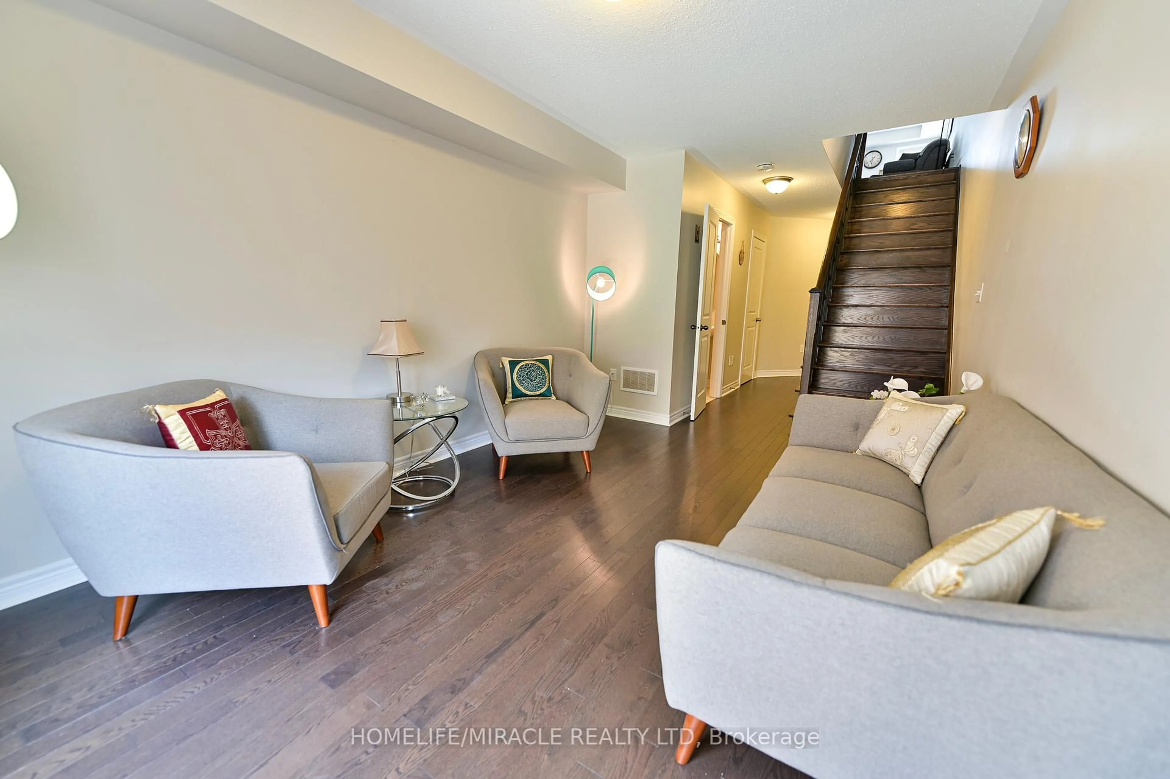 Living room with furniture, wood/laminate floor for 27 Pennycross Cres #3, Brampton Ontario L7A 4M1