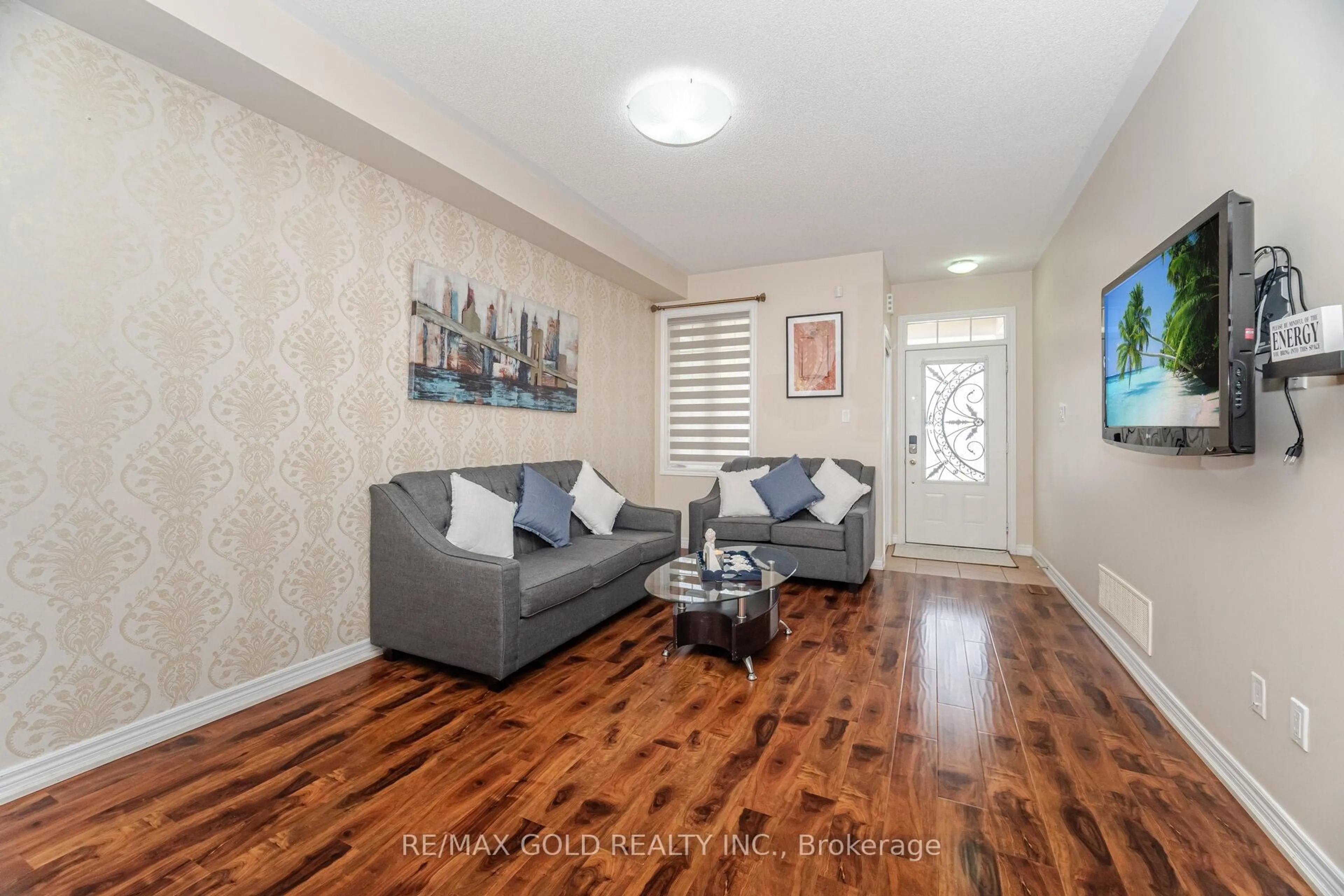 Living room with furniture, wood/laminate floor for 13 Fawson Cove Way, Brampton Ontario L6R 0G7