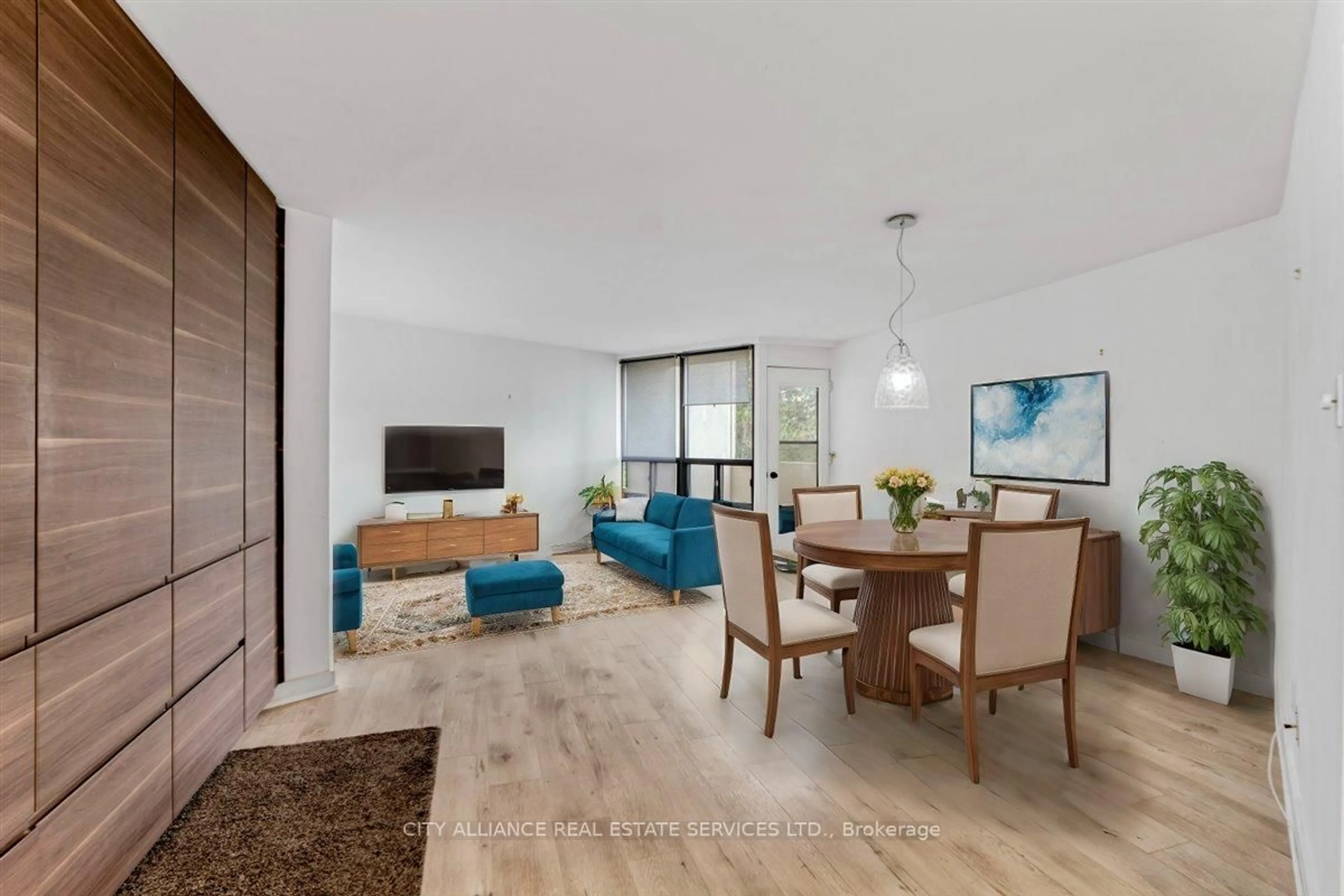 Living room with furniture, wood/laminate floor for 284 Mill Rd #A25, Toronto Ontario M9C 4W6