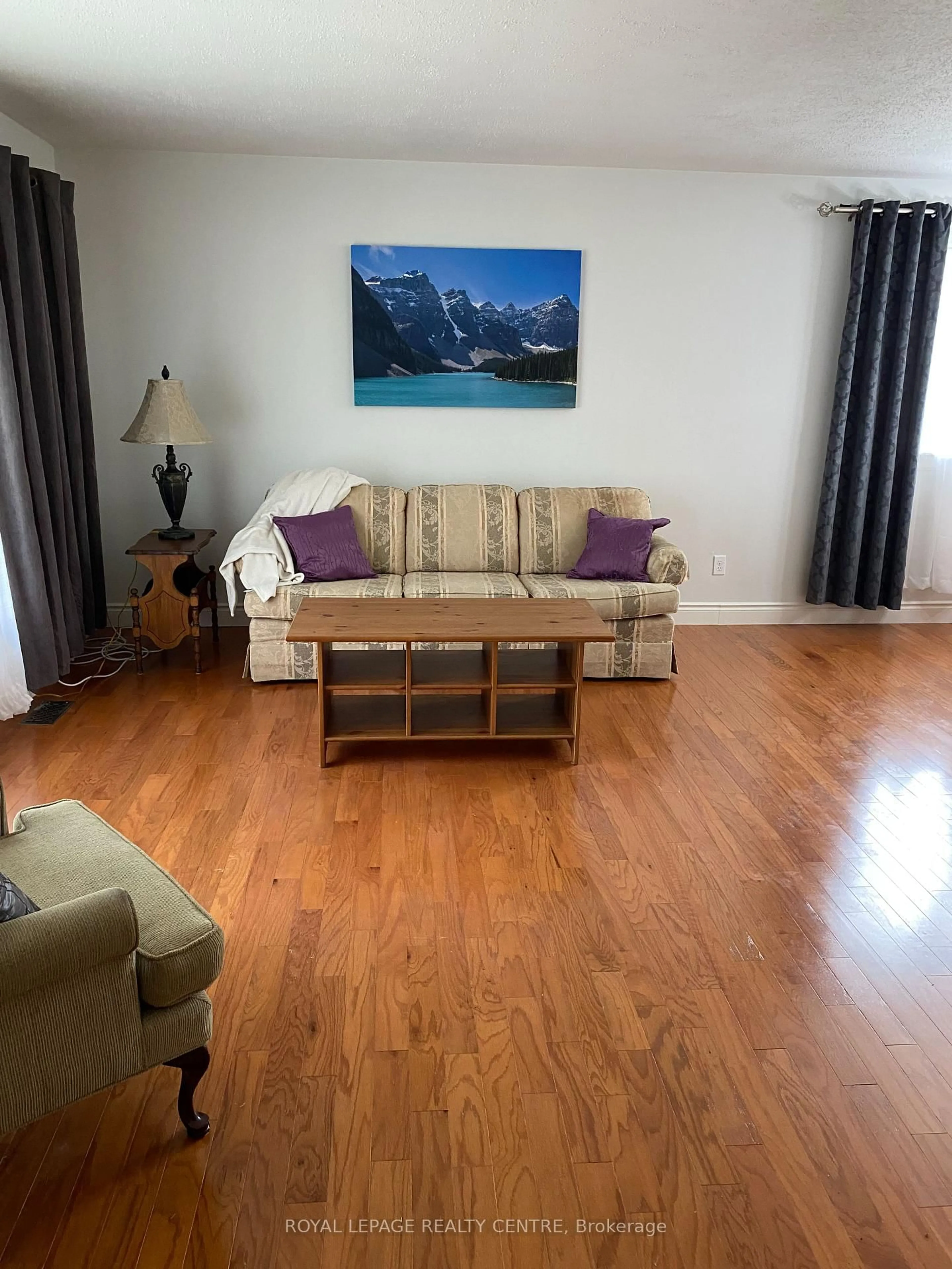 Living room with furniture, wood/laminate floor for 35 Aintree Cres, Brampton Ontario L6T 2T2