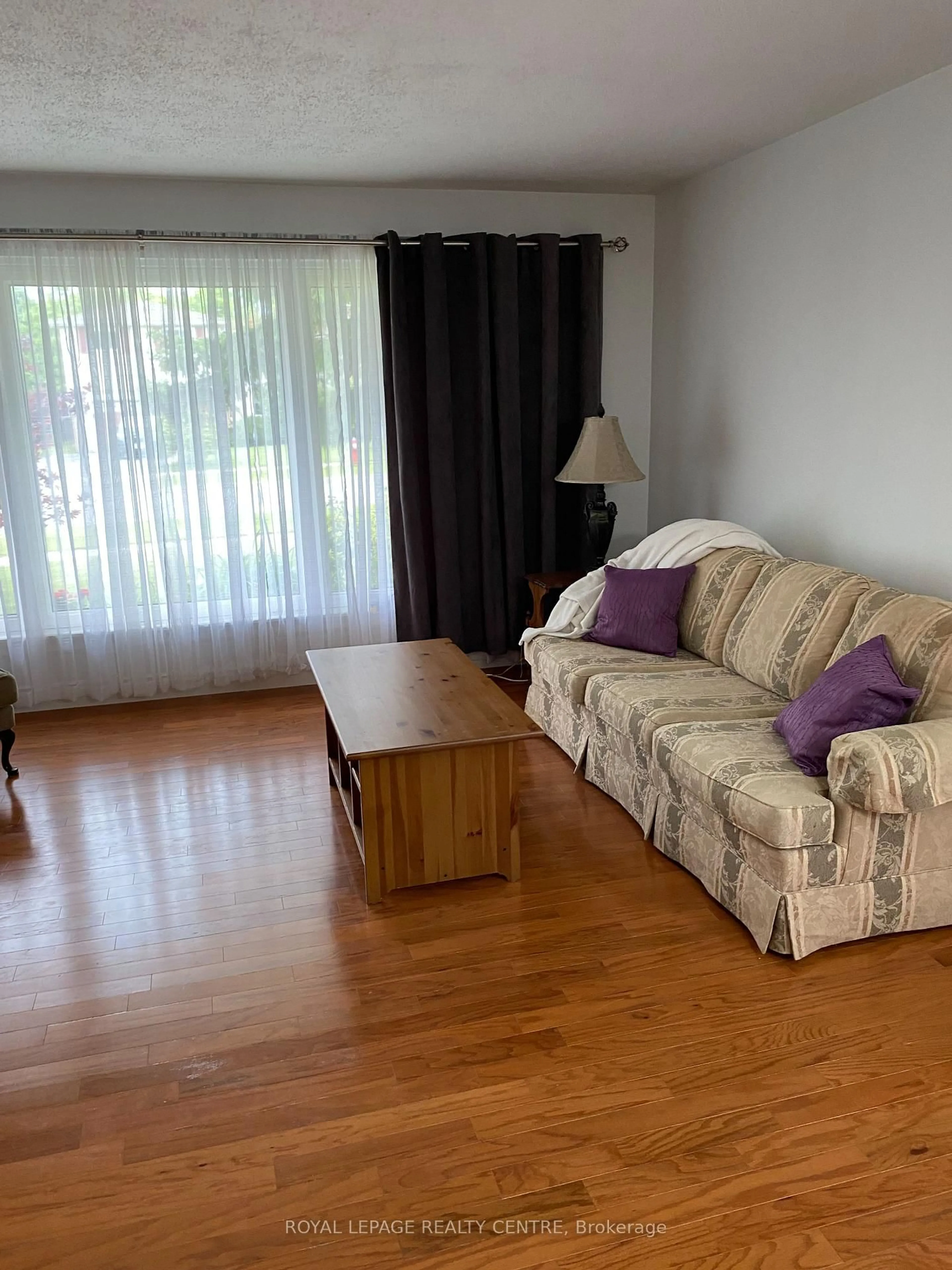 Living room with furniture, wood/laminate floor for 35 Aintree Cres, Brampton Ontario L6T 2T2