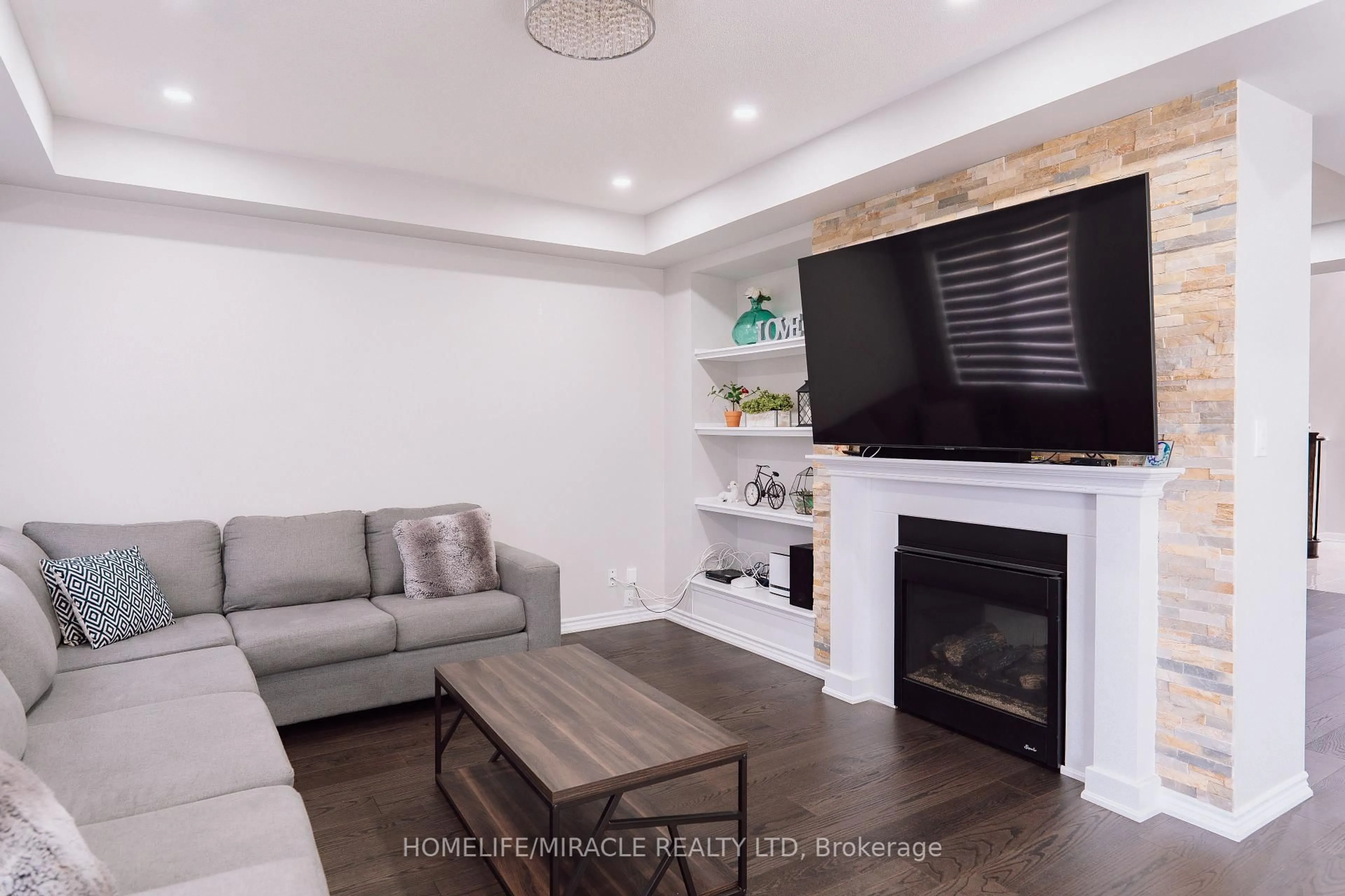 Living room with furniture, wood/laminate floor for 94 Mincing Tr, Brampton Ontario L7A 4S9