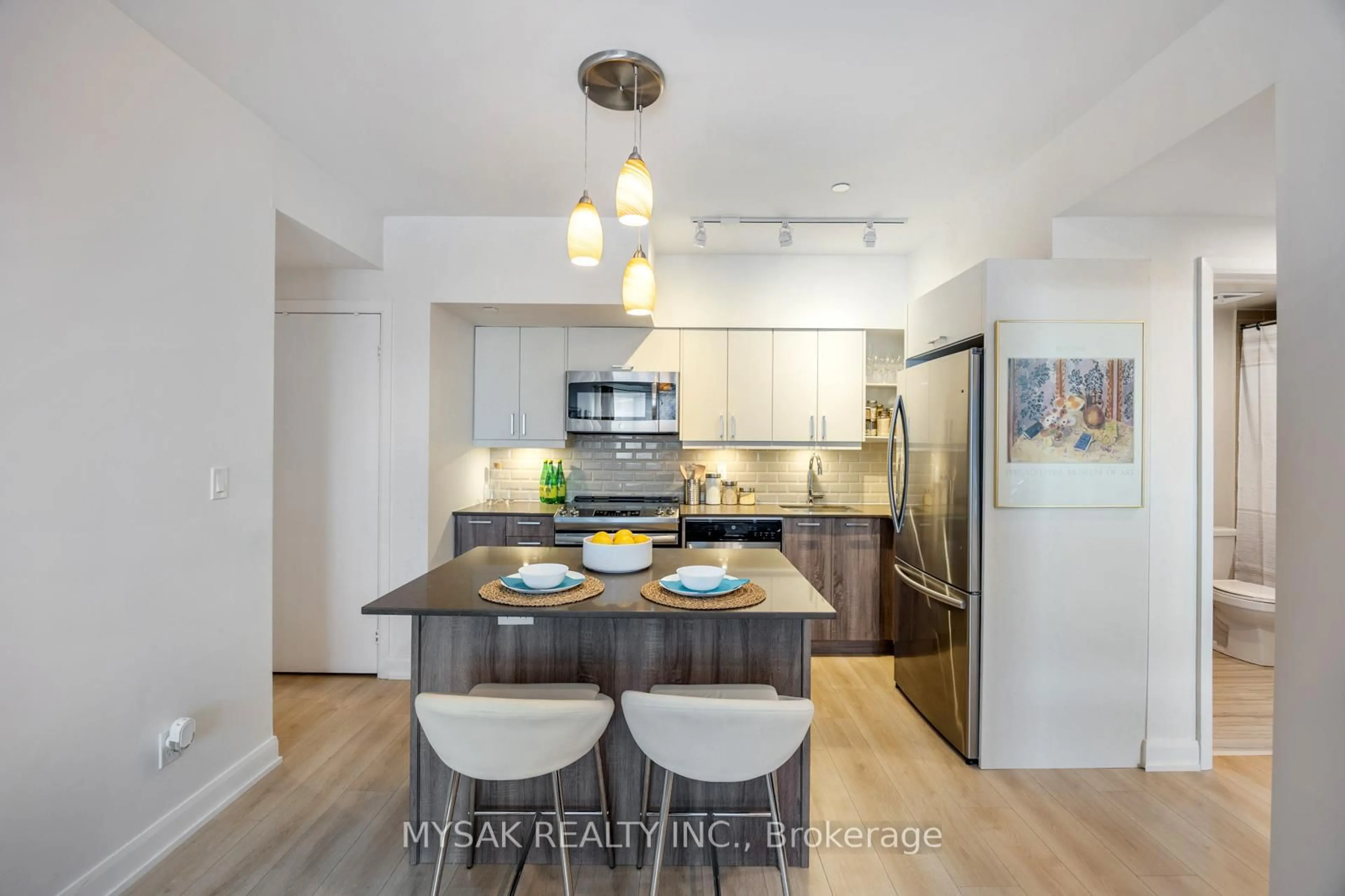 Open concept kitchen, wood/laminate floor for 385 Osler St #305, Toronto Ontario M6N 0B2