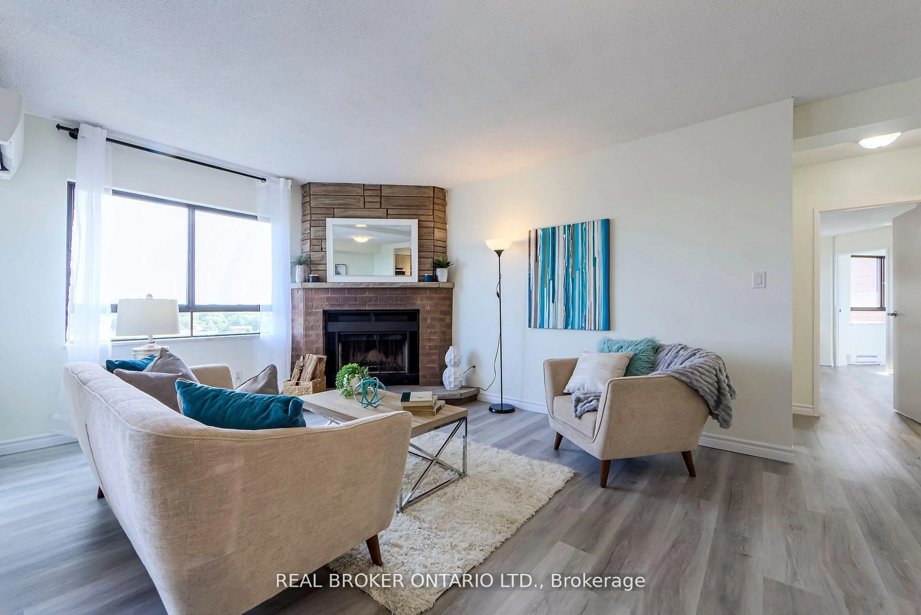 Living room with furniture, wood/laminate floor for 1000 Cedarglen Gate #611, Mississauga Ontario L5C 3Z5