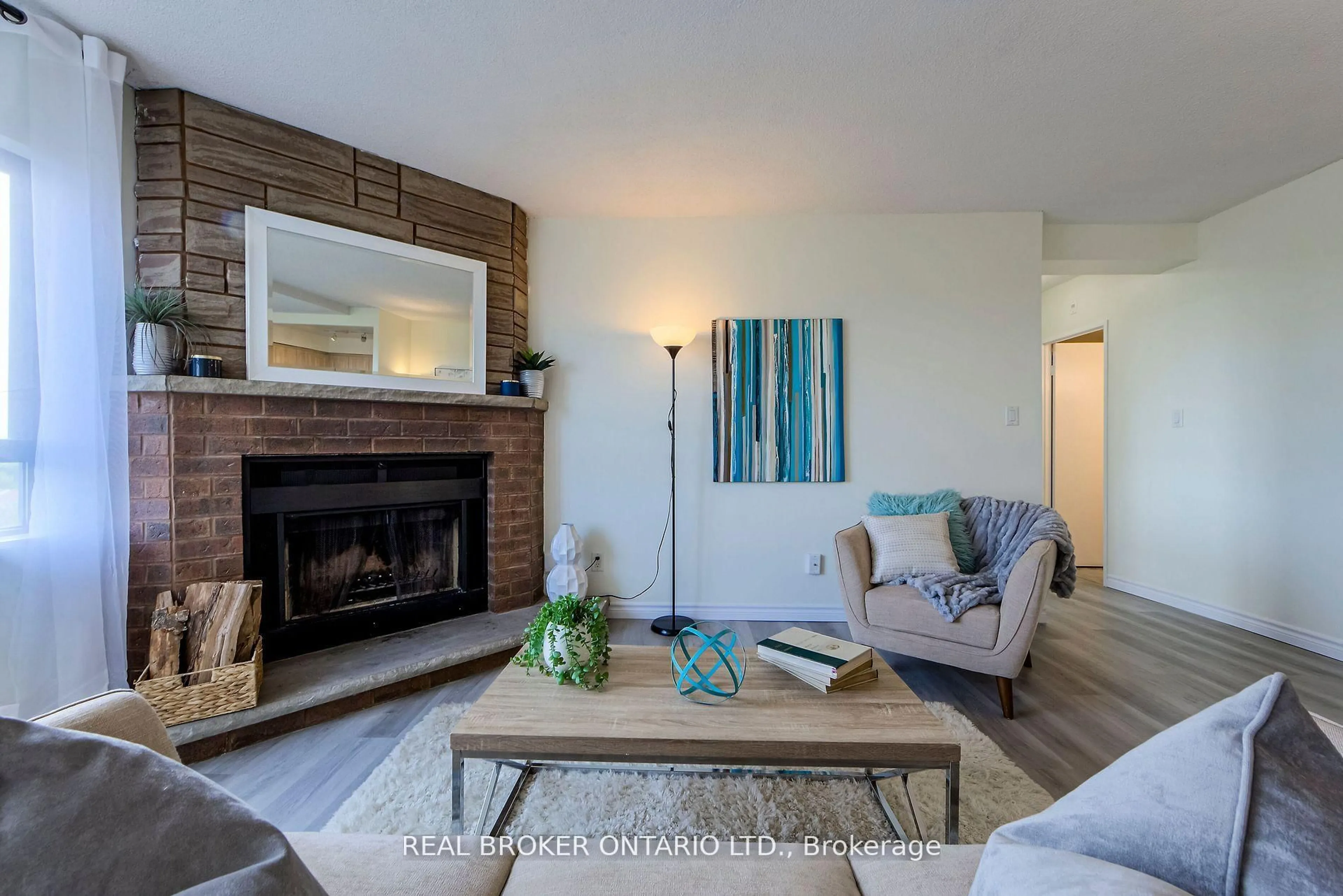 Living room with furniture, wood/laminate floor for 1000 Cedarglen Gate #611, Mississauga Ontario L5C 3Z5