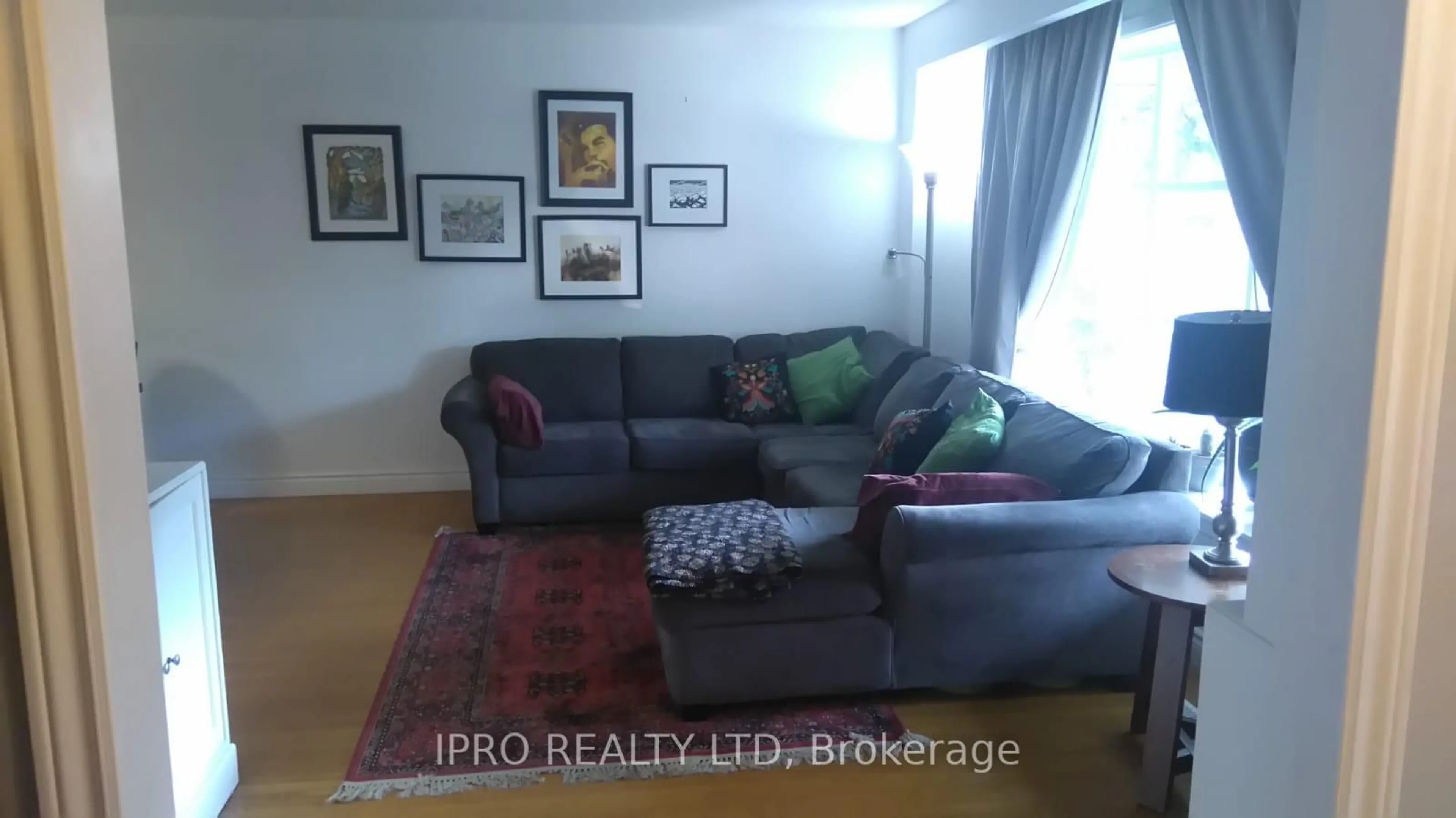 Living room with furniture, wood/laminate floor for 62 Ambleside Dr, Brampton Ontario L6Y 1B9