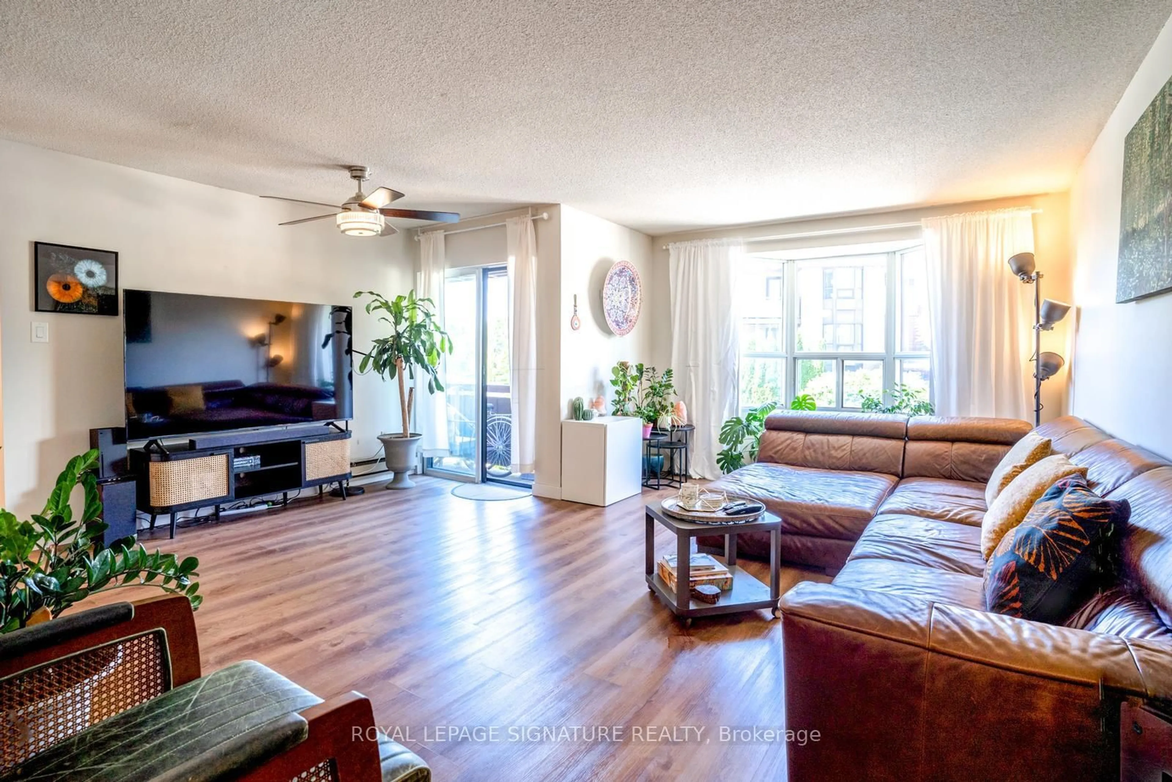 Living room with furniture, wood/laminate floor for 3841 Lake Shore Blvd #218, Toronto Ontario M8W 1R2
