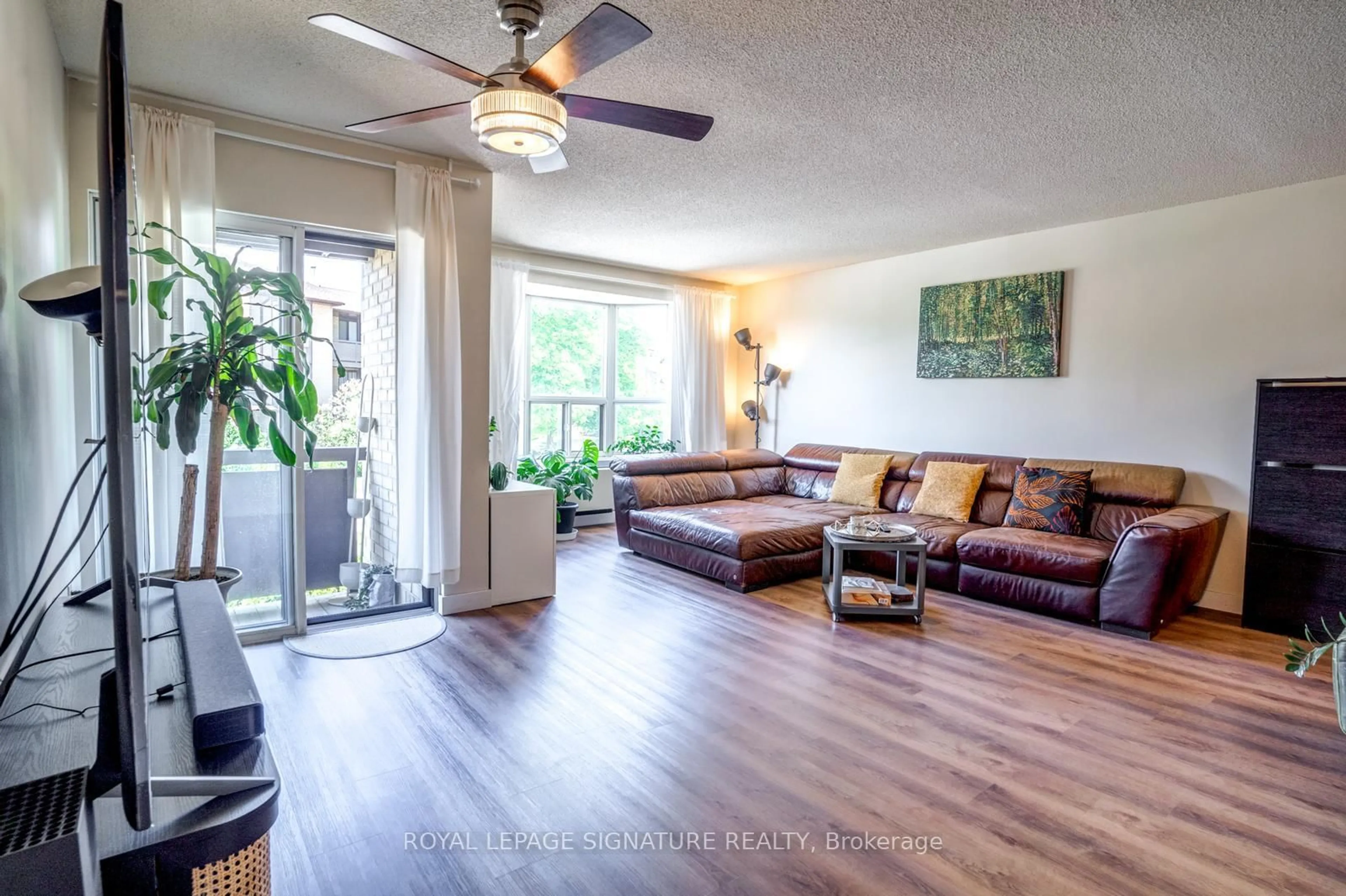 Living room with furniture, wood/laminate floor for 3841 Lake Shore Blvd #218, Toronto Ontario M8W 1R2