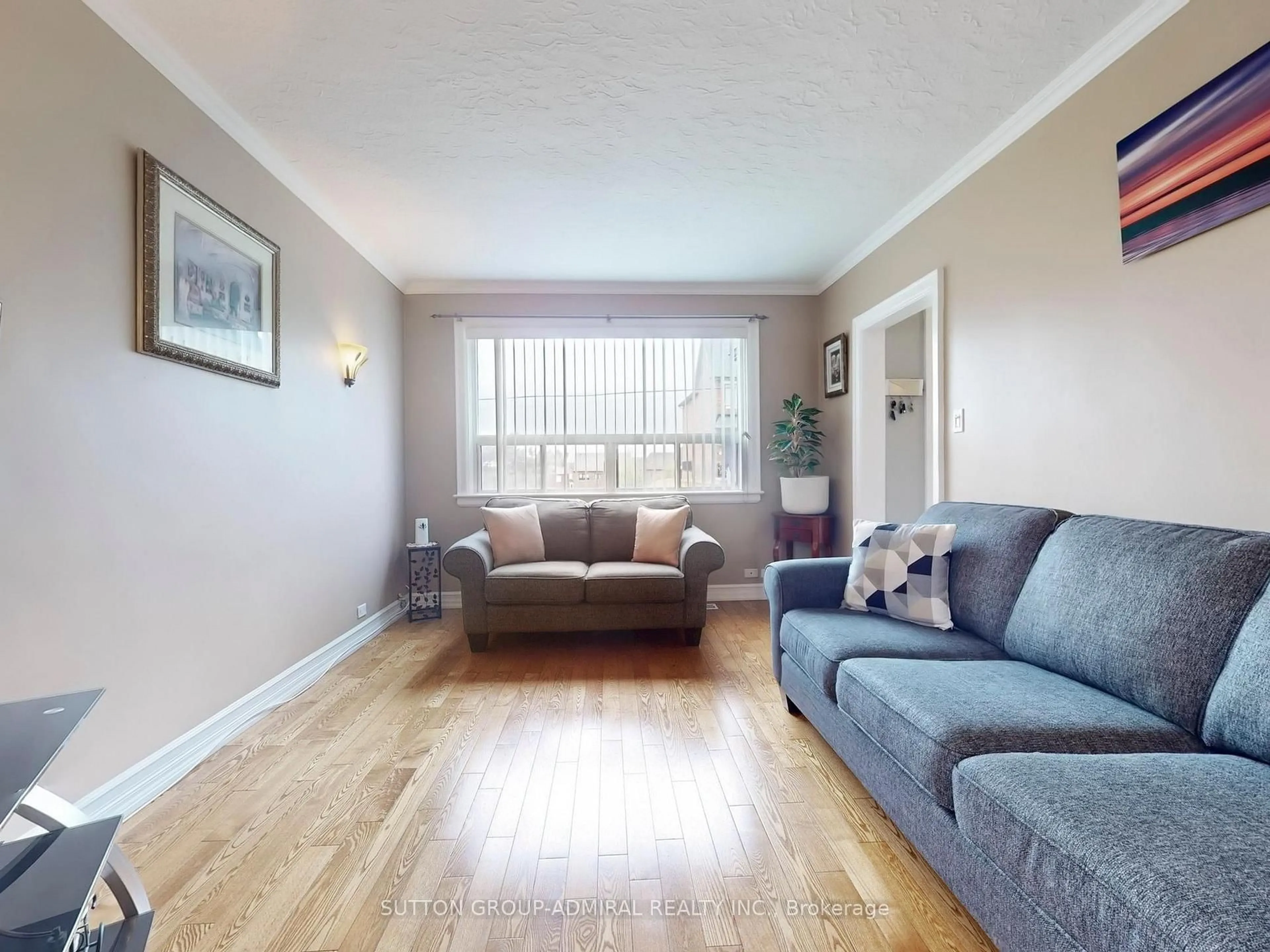 Living room with furniture, wood/laminate floor for 293 Kane Ave, Toronto Ontario M3M 3N9