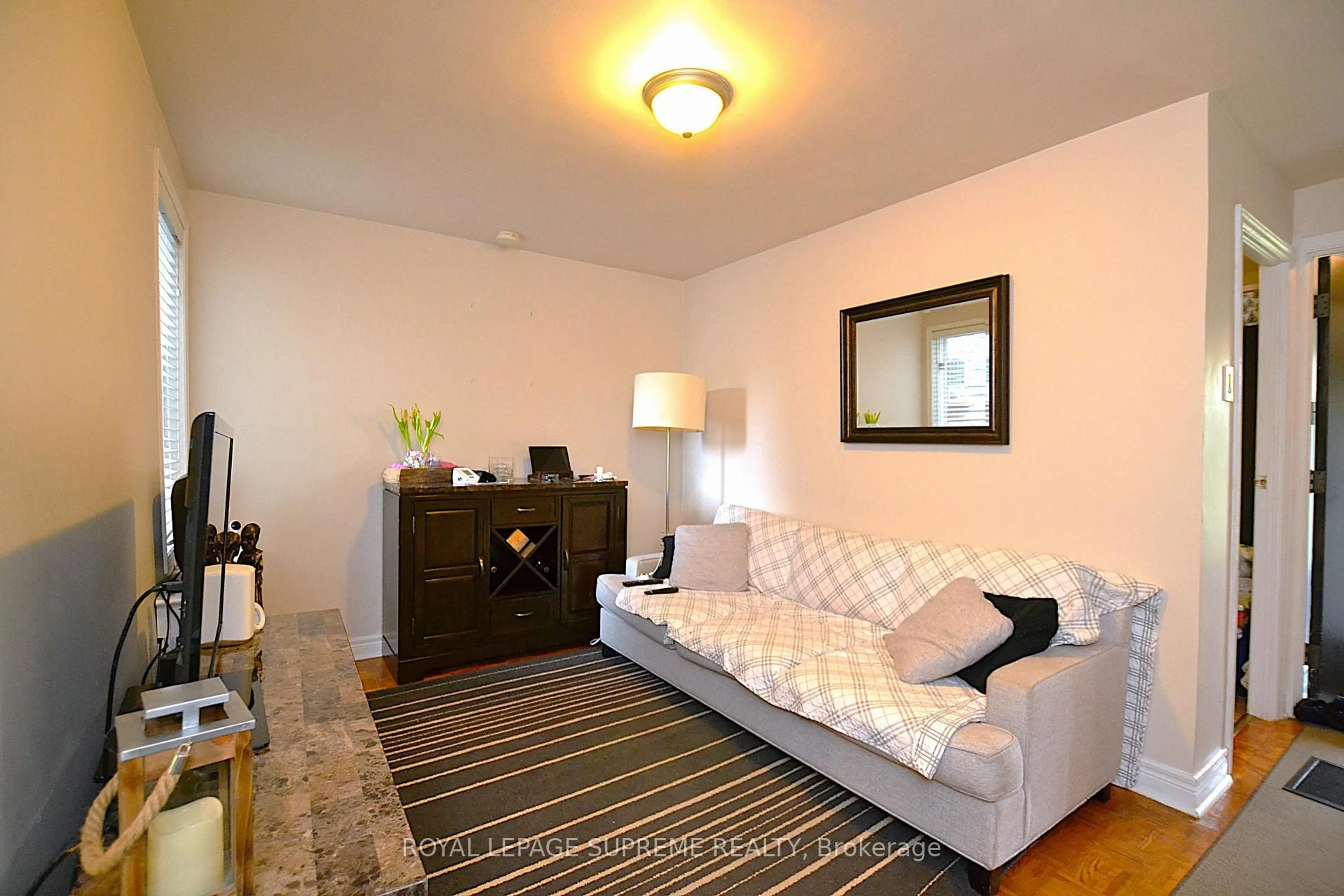 Living room with furniture, wood/laminate floor for 4 Chandos Ave, Toronto Ontario M6H 2E5
