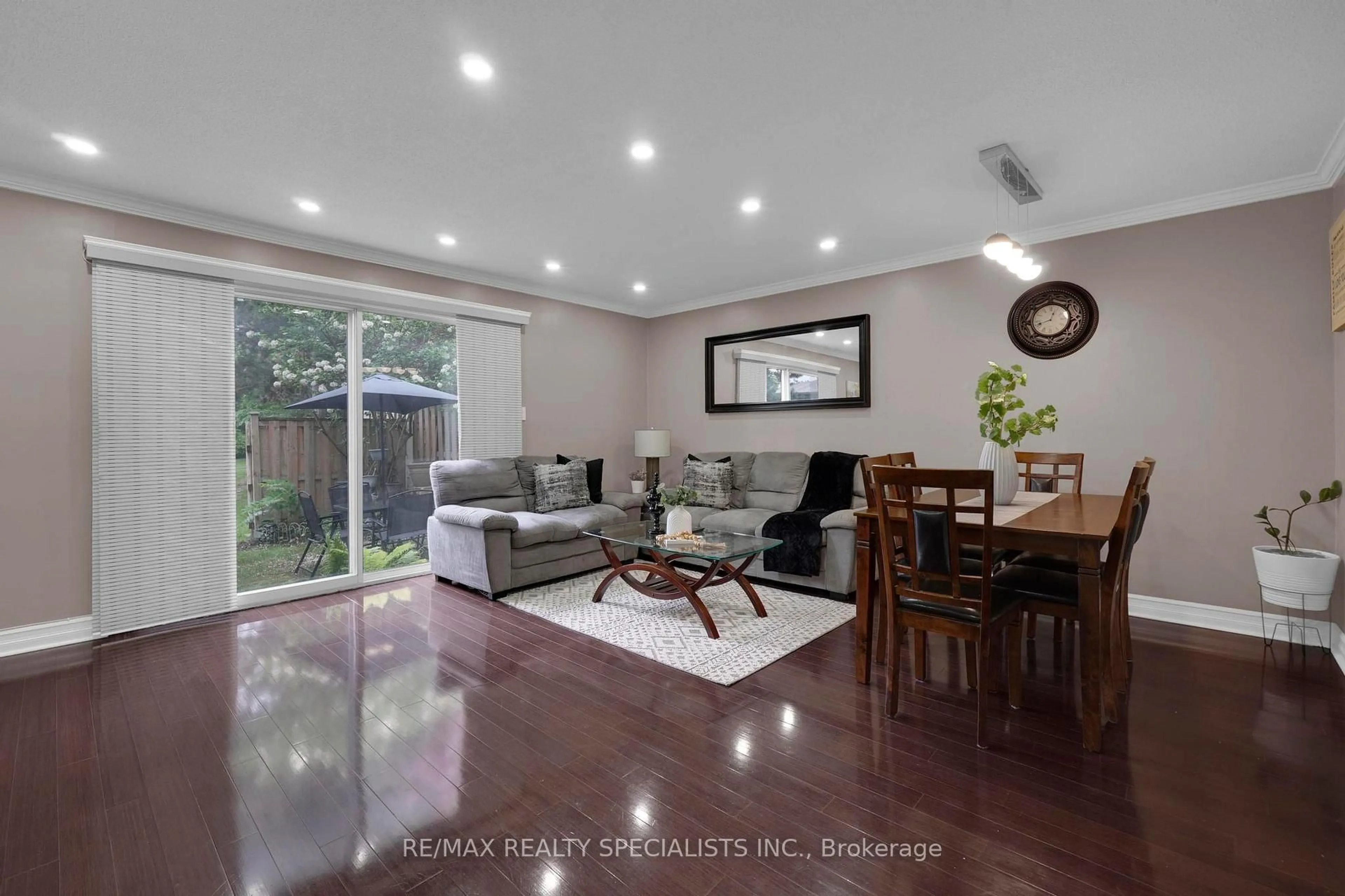 Living room with furniture, wood/laminate floor for 6650 Falconer Dr #107, Mississauga Ontario L5N 1B5