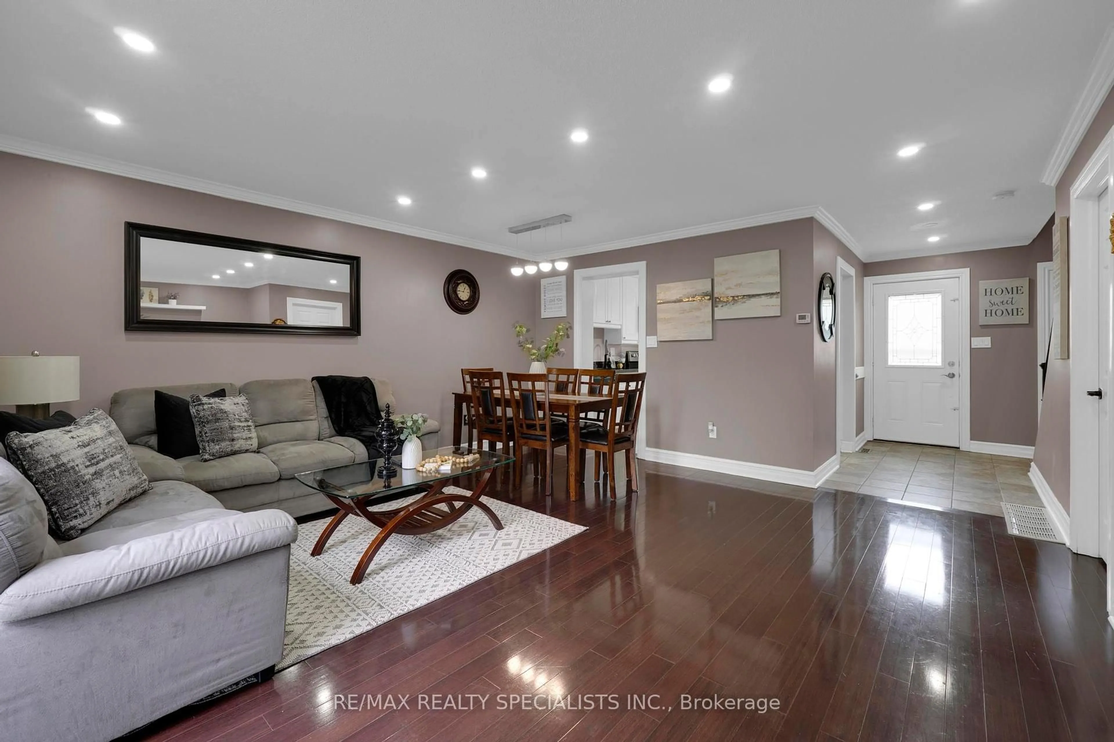 Living room with furniture, wood/laminate floor for 6650 Falconer Dr #107, Mississauga Ontario L5N 1B5