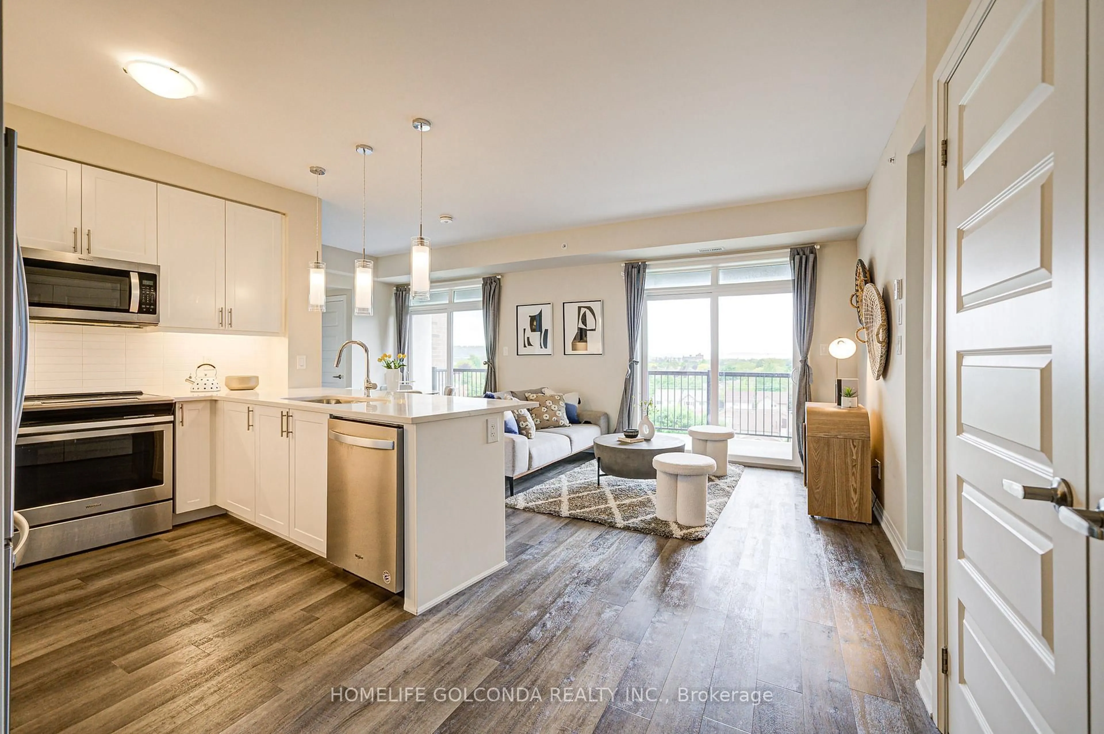 Open concept kitchen, wood/laminate floor for 610 Farmstead Dr #610, Milton Ontario L9T 8X5