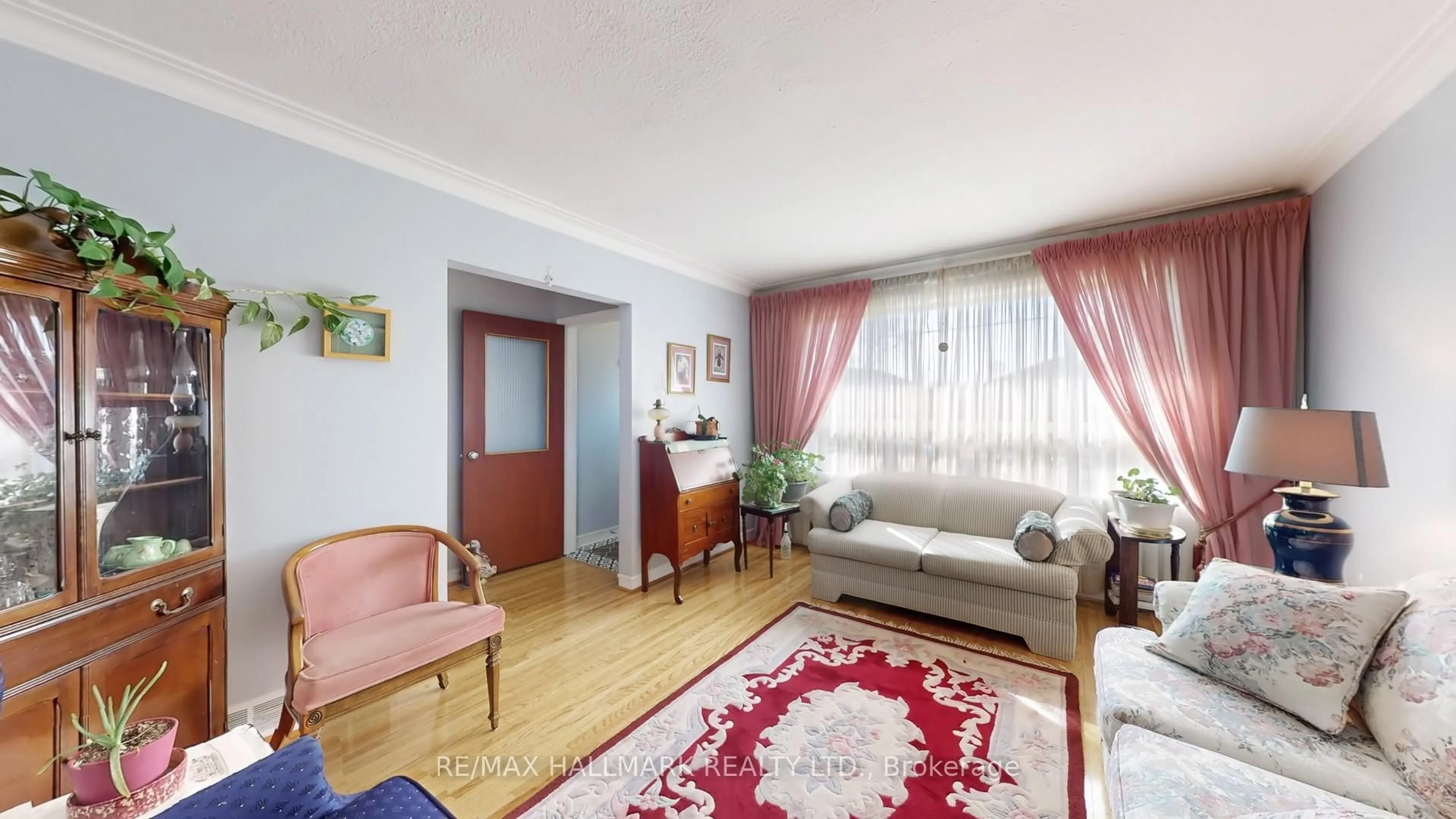 Living room with furniture, wood/laminate floor for 108 Plewes Rd, Toronto Ontario M3K 1K9