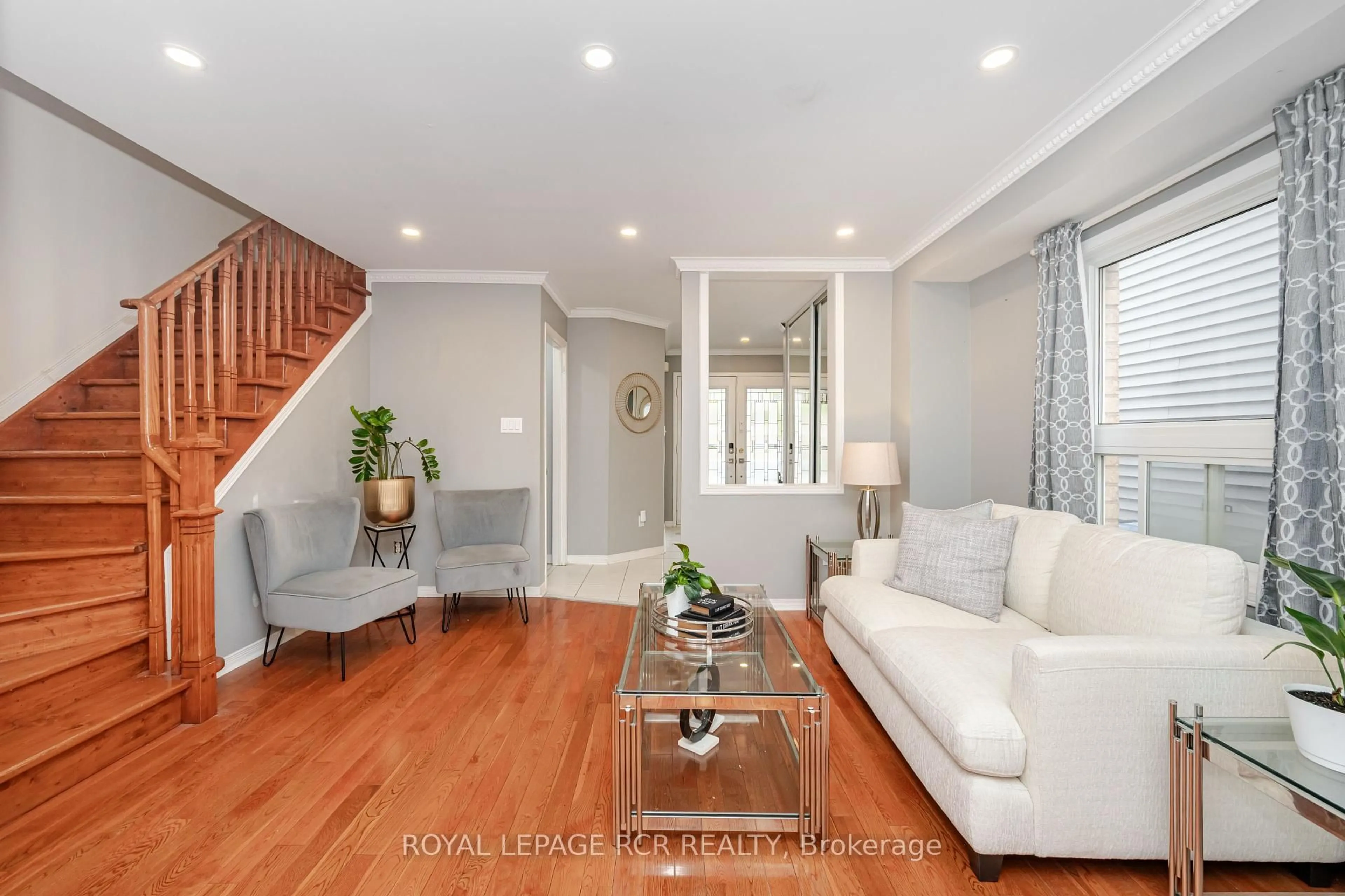 Living room with furniture, wood/laminate floor for 127 Tiller Tr, Brampton Ontario L6X 4S9